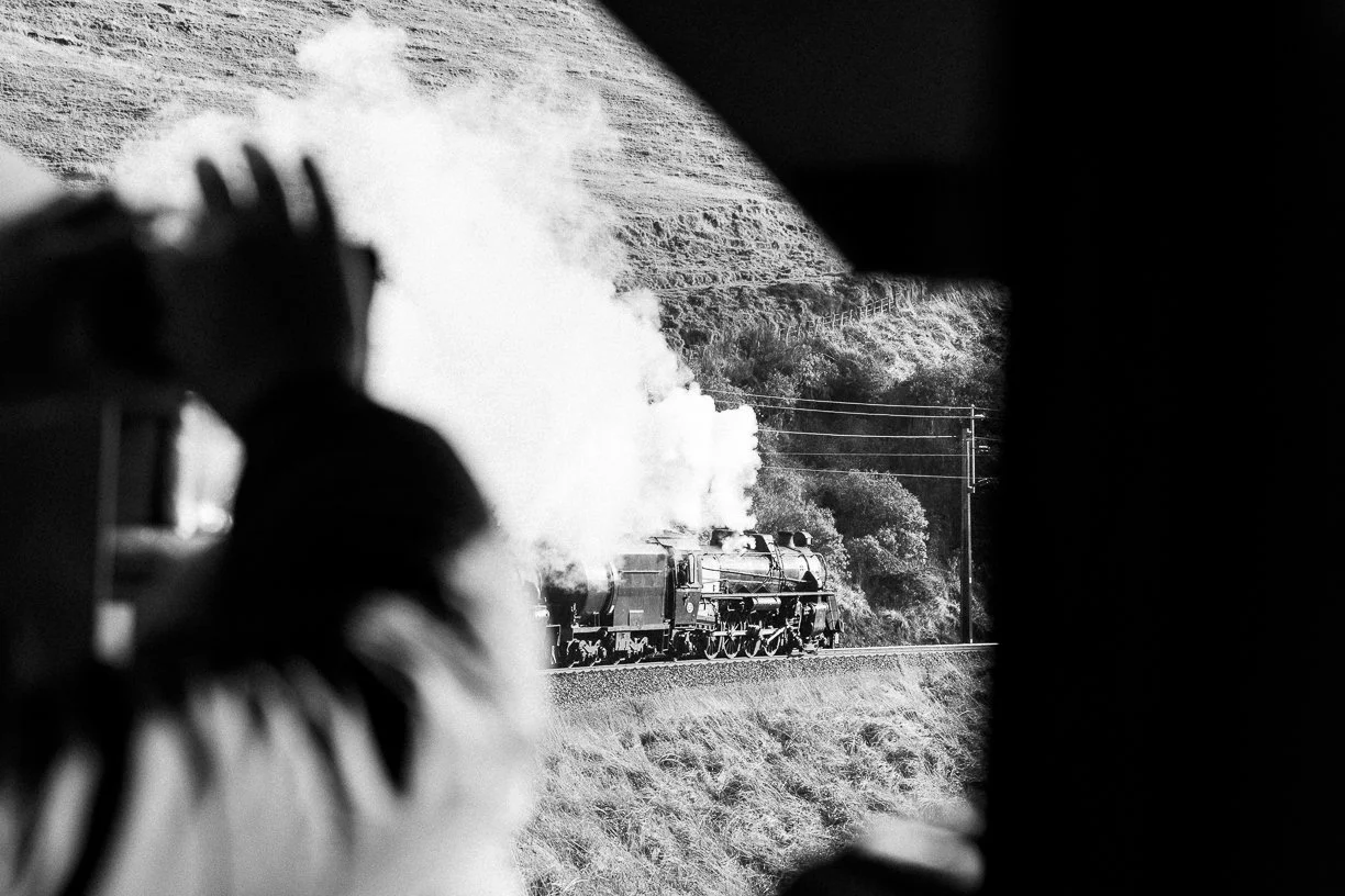 New Zealand FRONZ 50th anniversary Main Trunk Steam Spectacular train being hauled by Steam Incorporated locomotives Ja 1271 and  Ab 608 as a photographer looks on from the observation car. Scott Gould A Railway life photography.