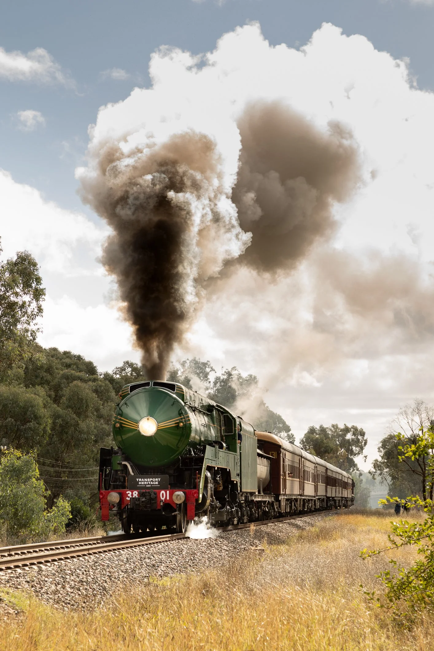 3801 and heritage train climbing out of Wagga Wagga at Kapooka, with the new highway overpass in the background. Scott Gould A Railway Life photography