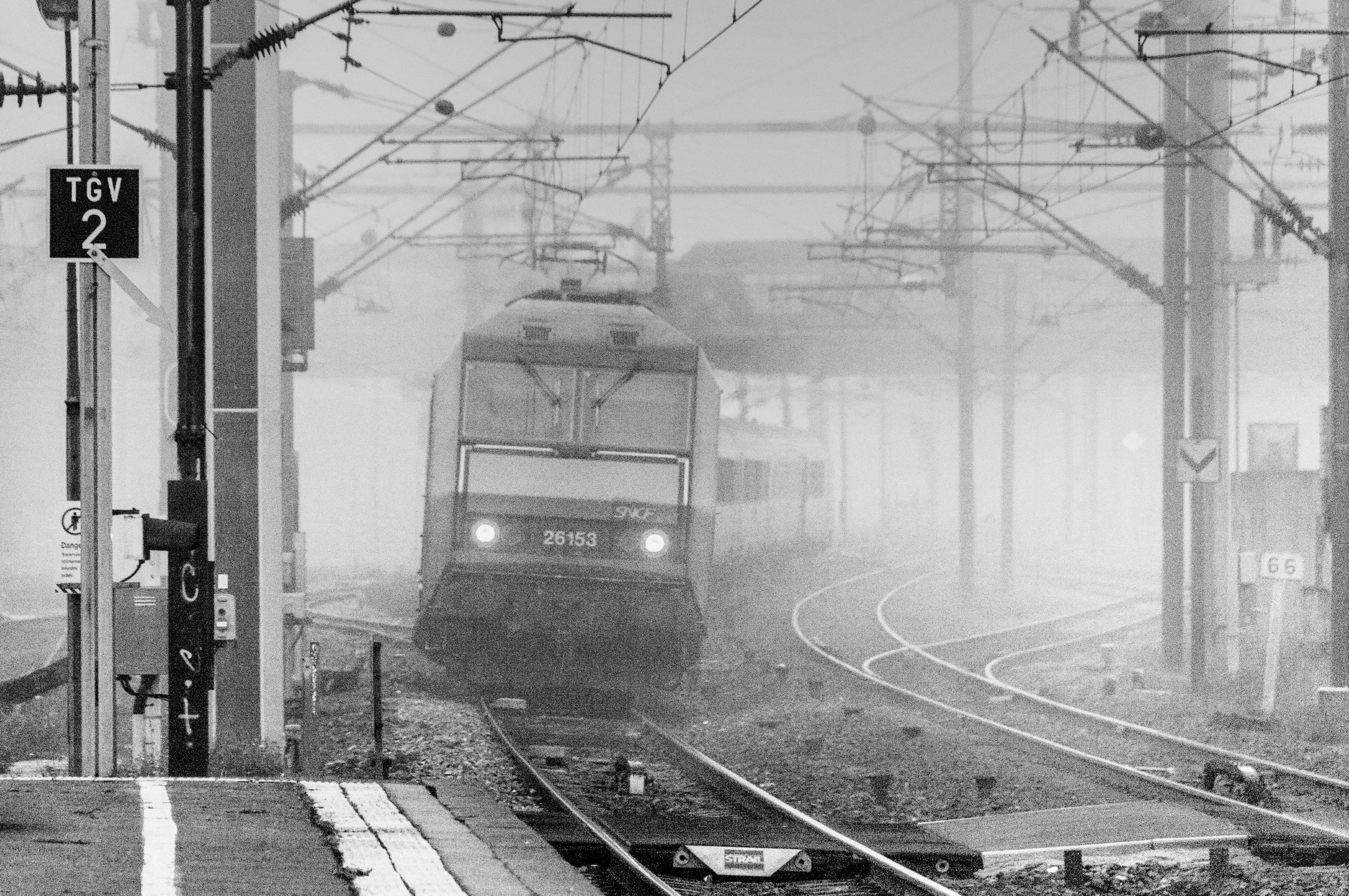 A SNCF train hauled by electric locomotive 26153 arriving at Colmar with a train bound for Strasbourg black and white railway photography fine art photo taken by Scott Gould A Railway Life fine art photography train photo