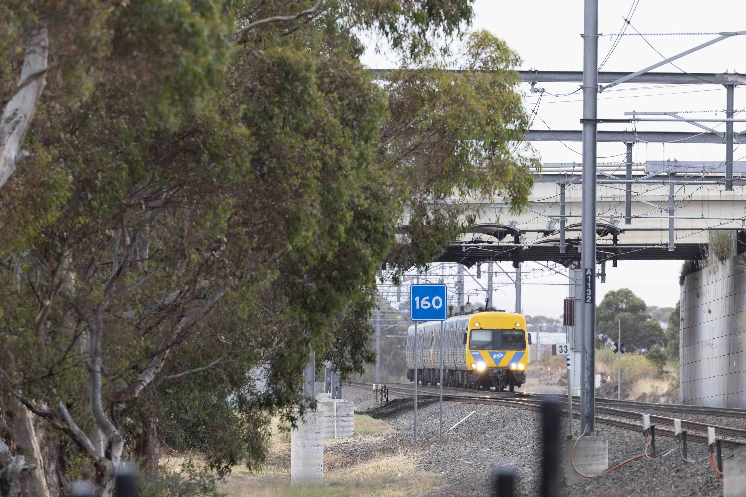 Sunbury Line comeng suburban train approaching Diggers Rest passing under Calder Freeway bridge. A Railway Life photography Scott Gould
