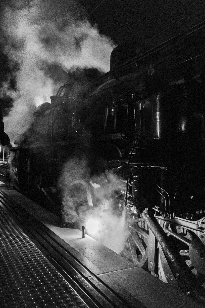 black and white railway photography fine art photo Taken by Scott Gould A Railway Life fine art photography loco AB1271 receives some attention at Palmerston North under torchlight on the return leg of the Main Trunk Steam spectacular.