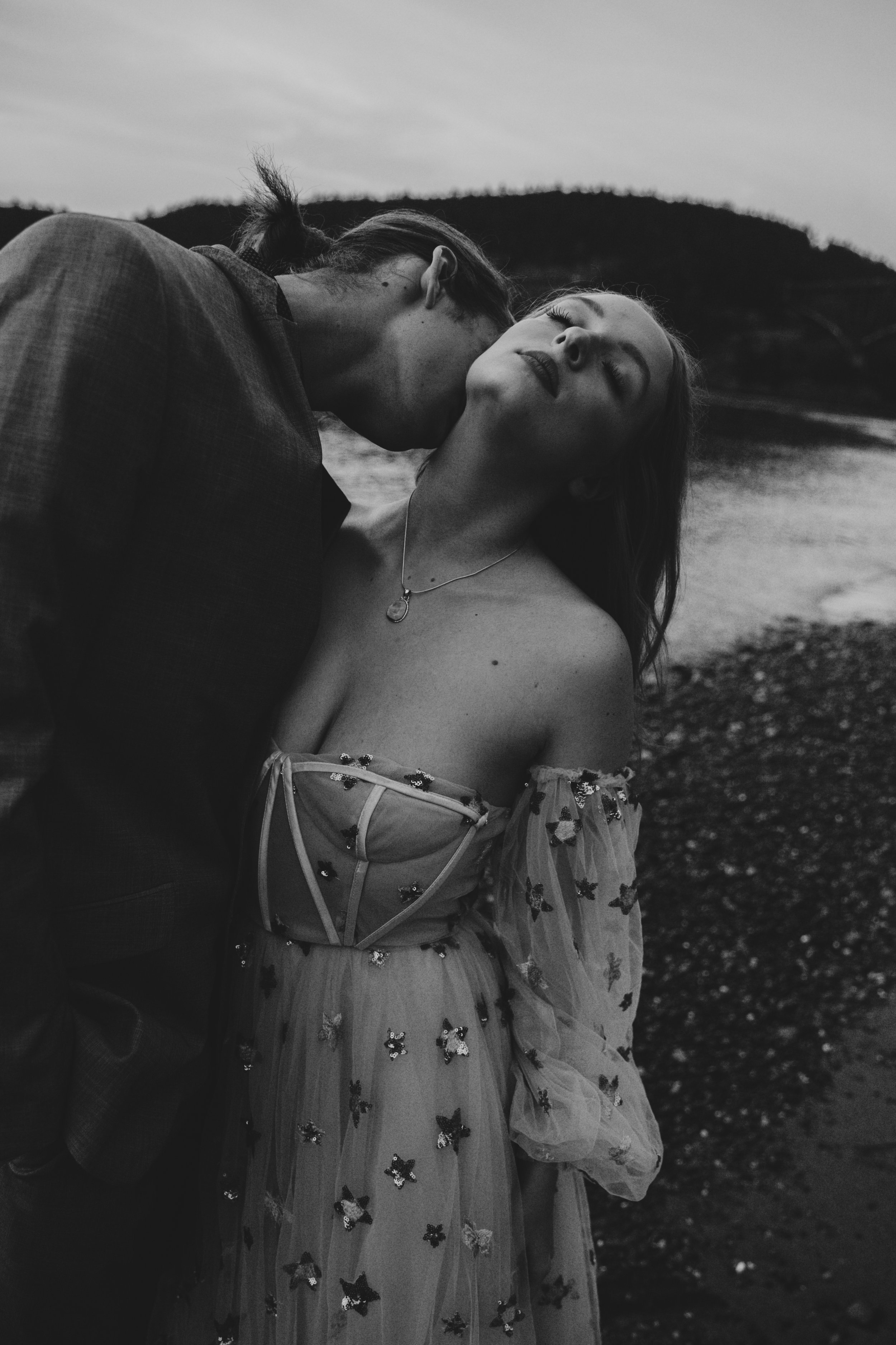 A moody black and white romantic portrait of an engaged couple. The photographer is Allison Zenner Photography, located in Snohomish County, Washington.