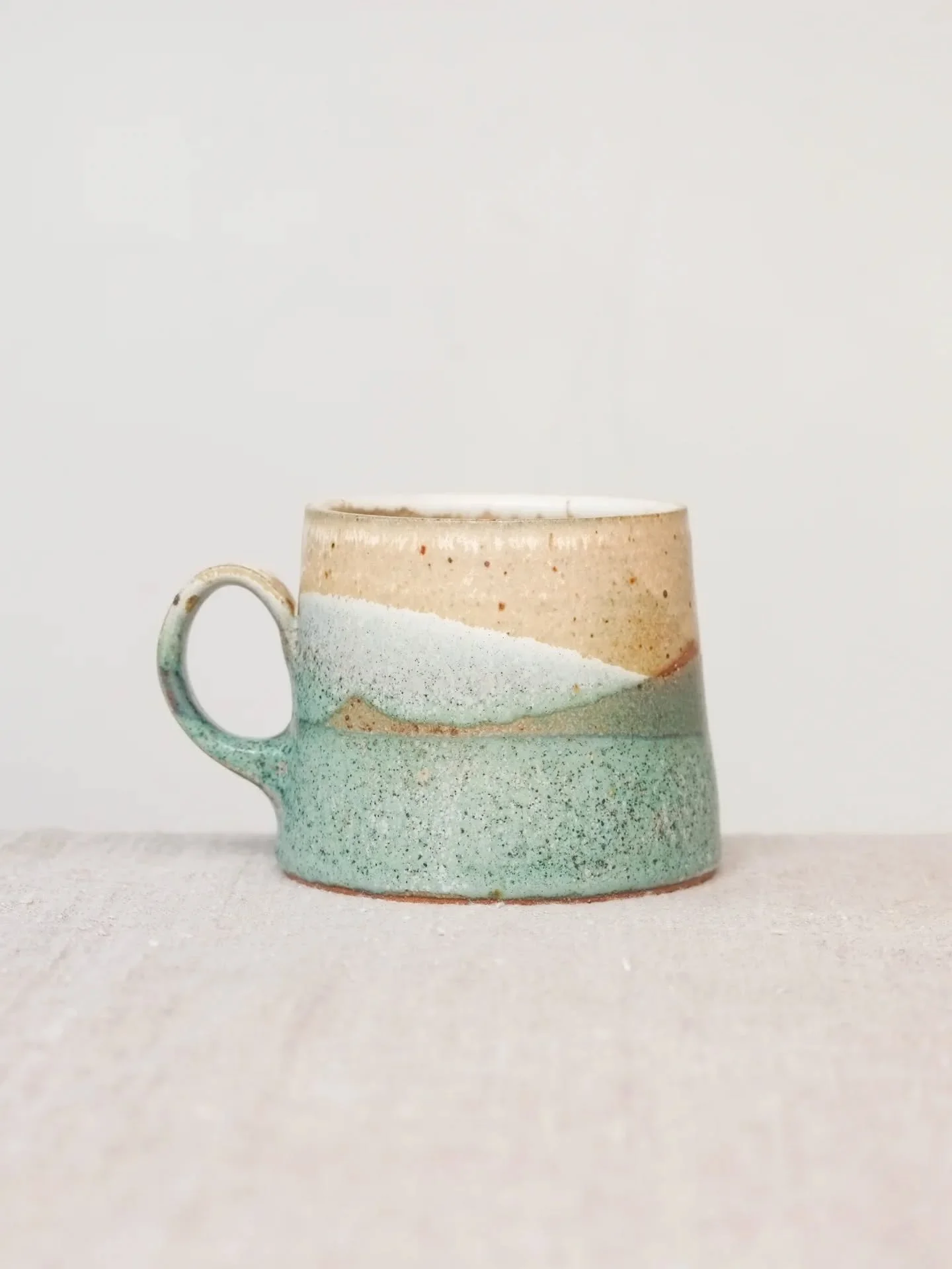 Here are mugs in three different clay bodies but exactly the same glazes. Not only do I have too many different buckets of glaze but I also have too many different bags of clay. That means a huge variety of possibilities. Then throw in the different 