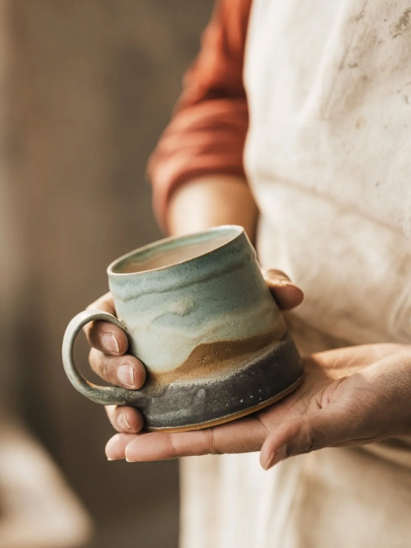Coastline mugs. I've been making pieces with this glaze combination for about six years now. I came up with them when I moved to Devon, after having spent five years in Australia. They simultaneously reminded me of the coastline where I lived in Nort