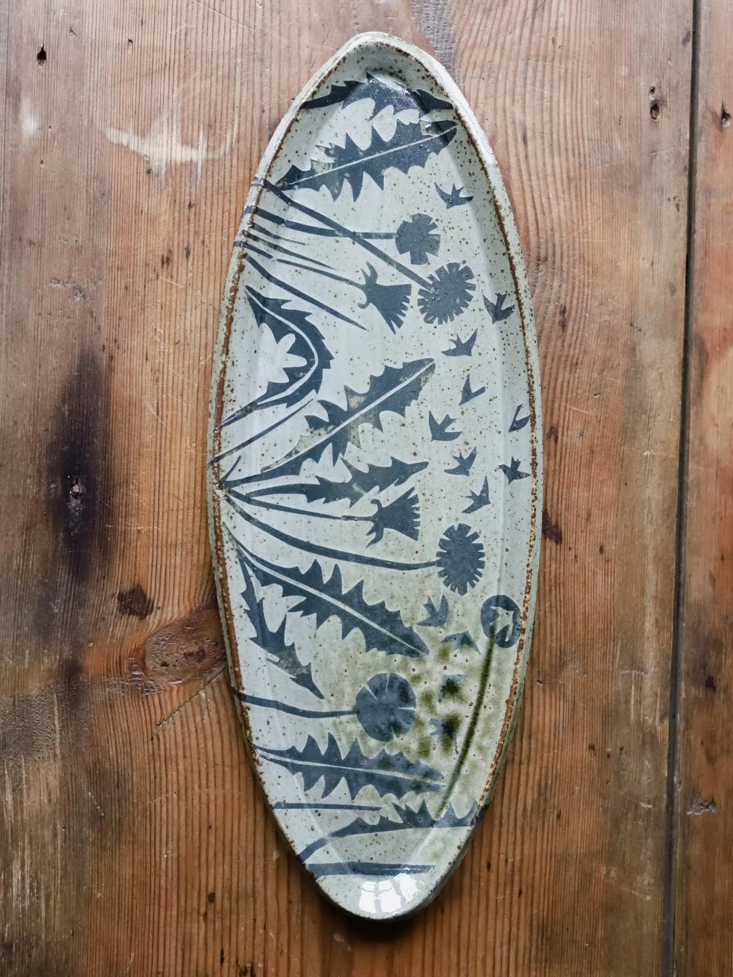 The Dandelion Platter. It's got to be one of the best platters yet, don't you think? It was fresh out of the kiln yesterday and I'm so pleased with it. You can see in the video where ash has melted on the right hand side and distorted the stencils re