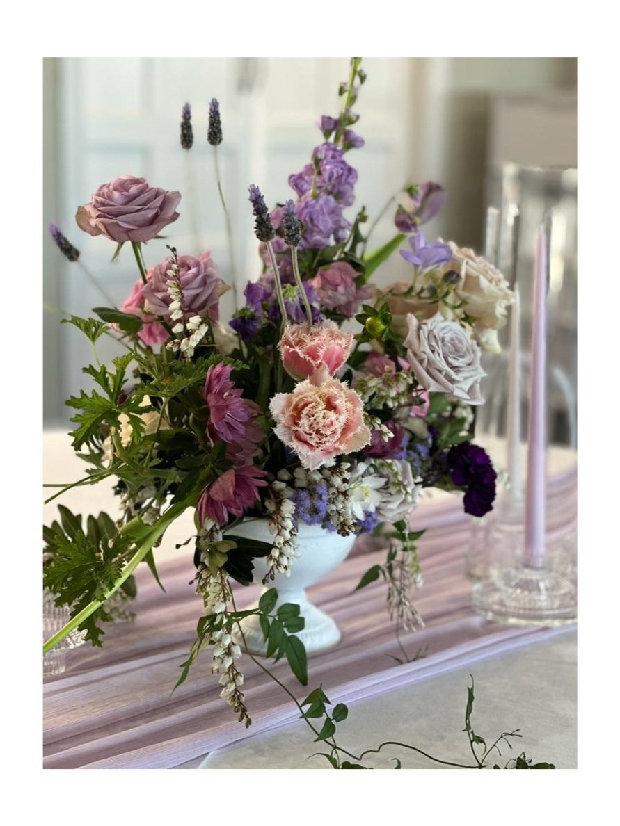 Mothers Day flower arrangement in white ceramic vase with seasonal pastel flowers