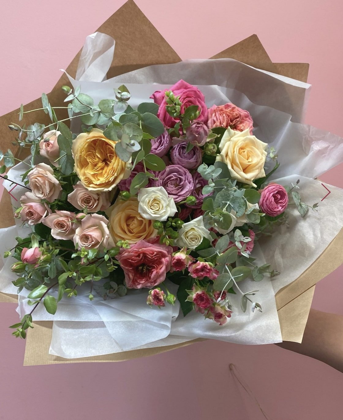 Mixed rose bouquet of locally grown roses, with seasonal foliage and beautiful wrapping. In pastel colours.