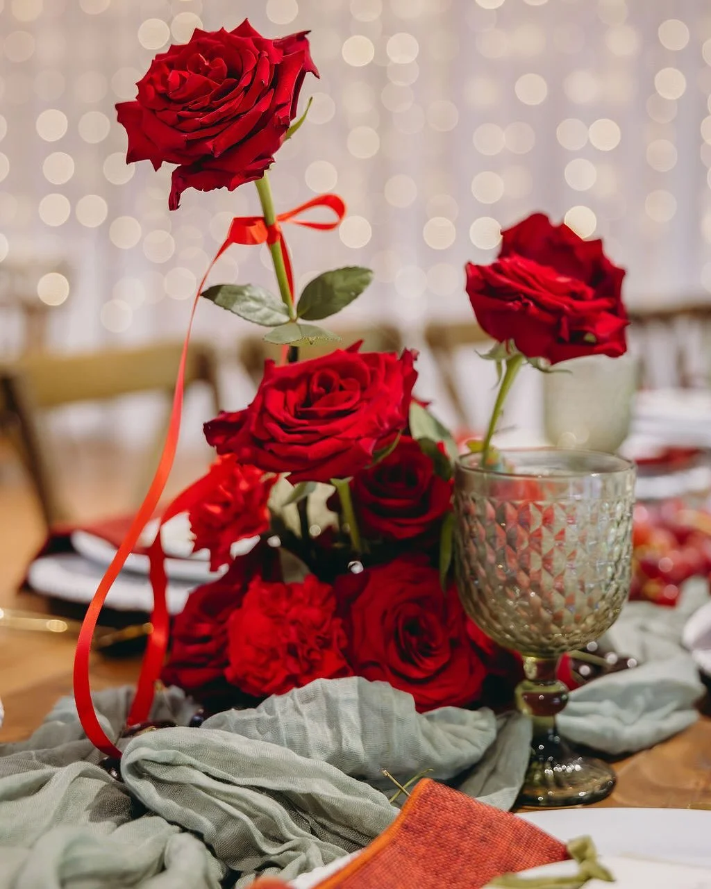 Festive feels, but make it chic 🥂

This rich red and sage green setup is giving modern Christmas magic &mdash; with a side of golden glow and party vibes.

Velvet reds, layered textures, bold blooms, and just the right amount of sparkle.

Perfect fo