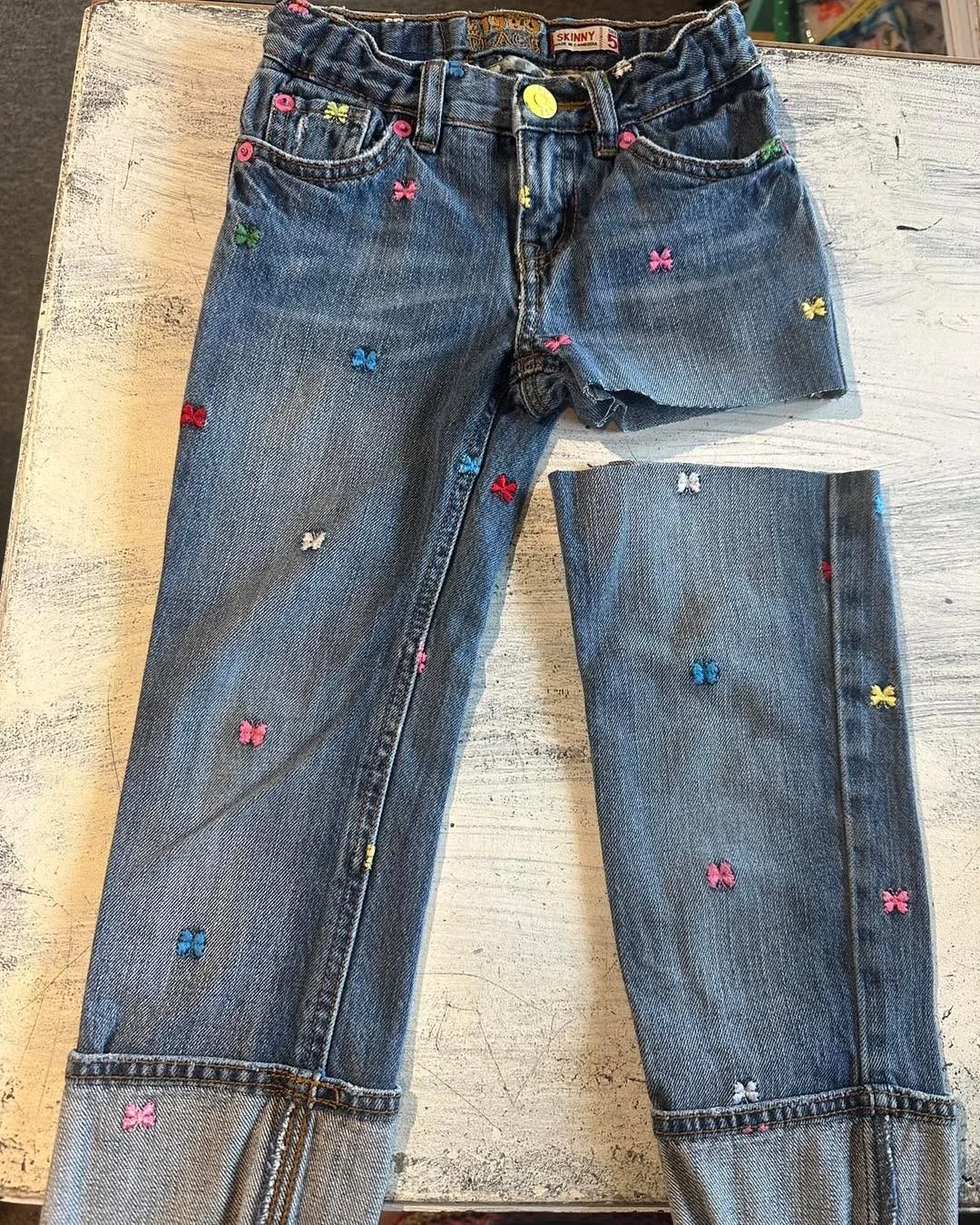 One of the best things about being a resale shop? Once we buy your items, they're ours to do with as we please✂️ ✂️ 

These jeans were a little outdated, but I couldn't resist that butterfly embroidery and leopard print. A quick "chop chop"
