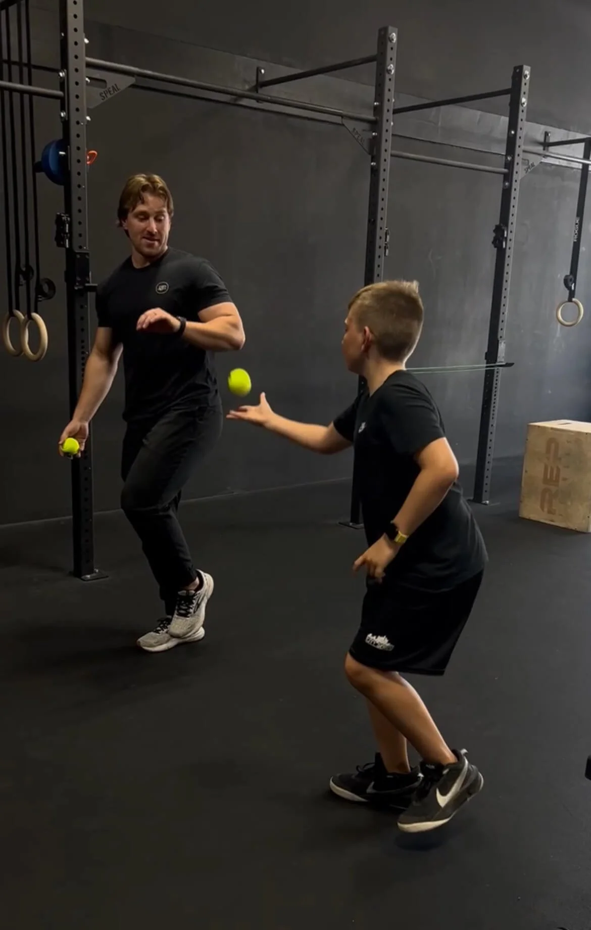 A young kid throwing a tennis ball during his physical therapy sports session with a physical therapist in Redlands, CA.