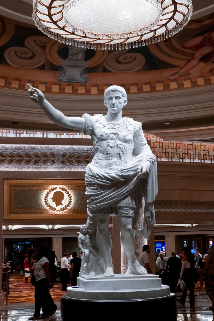 Marble statue under a chandelier