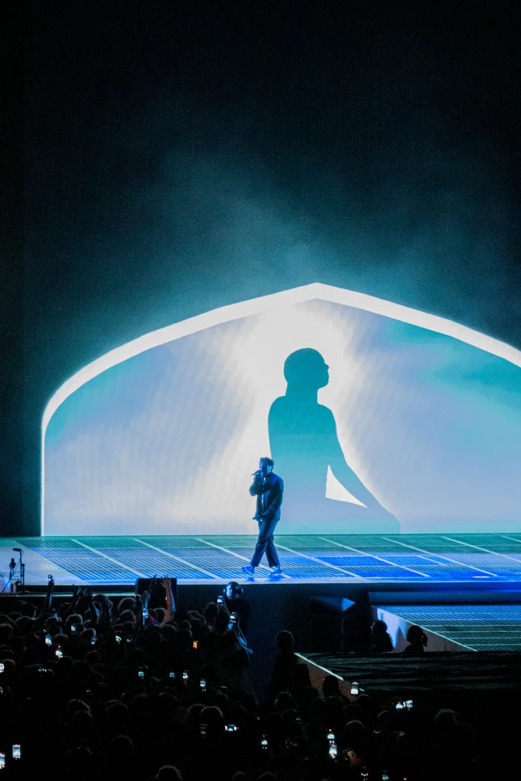 Artist with a large silhouette projection