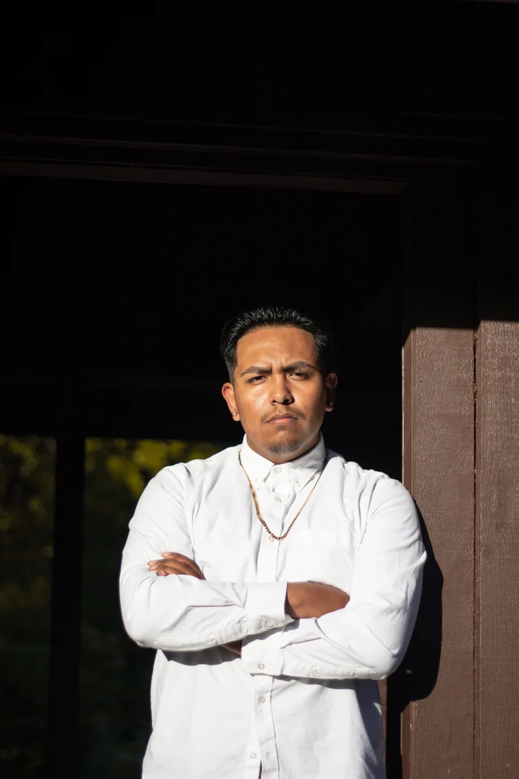 Man leaning against a door frame