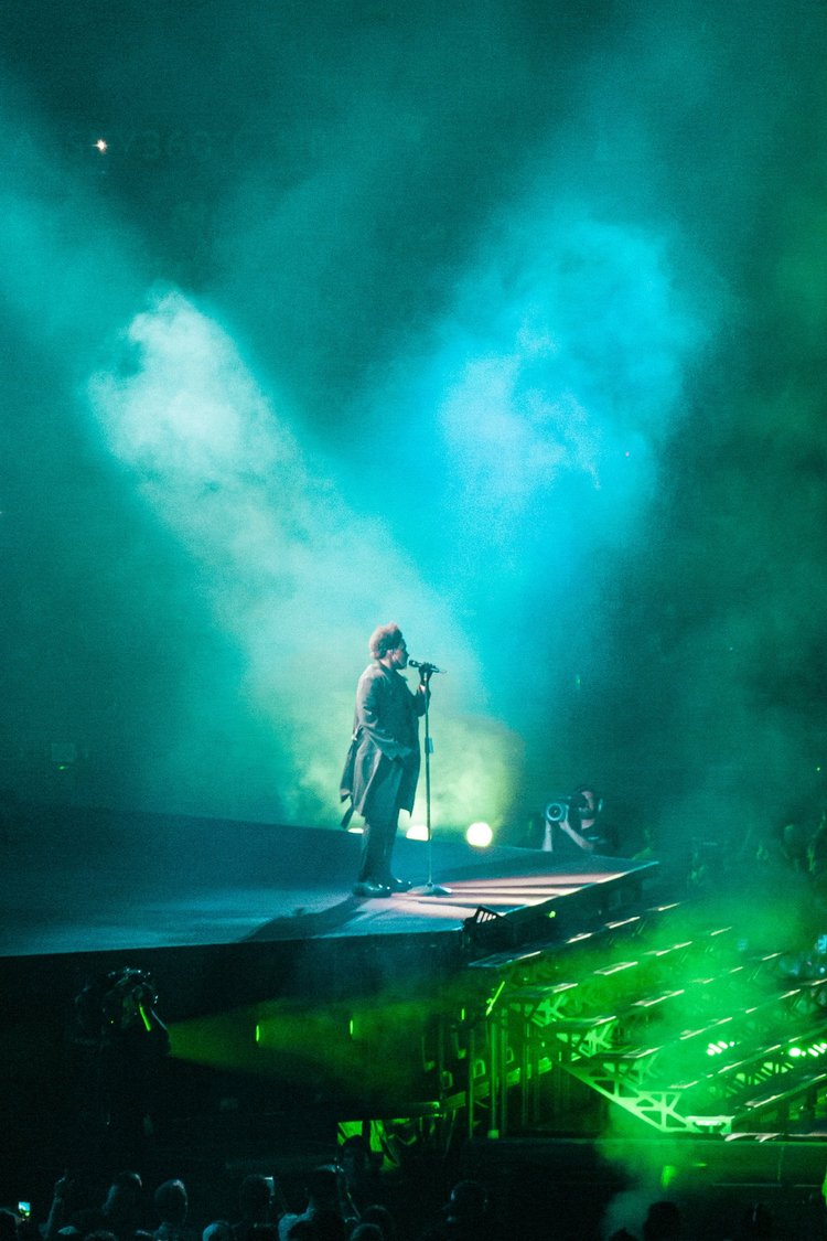 Singer under green and blue lights