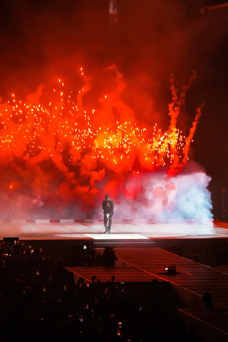 Performer in front of a red backdrop