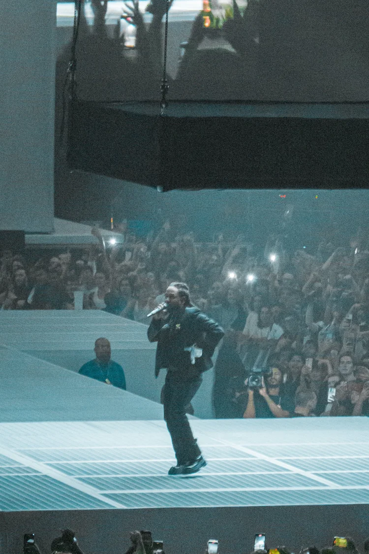 Performer singing to a crowd holding phones