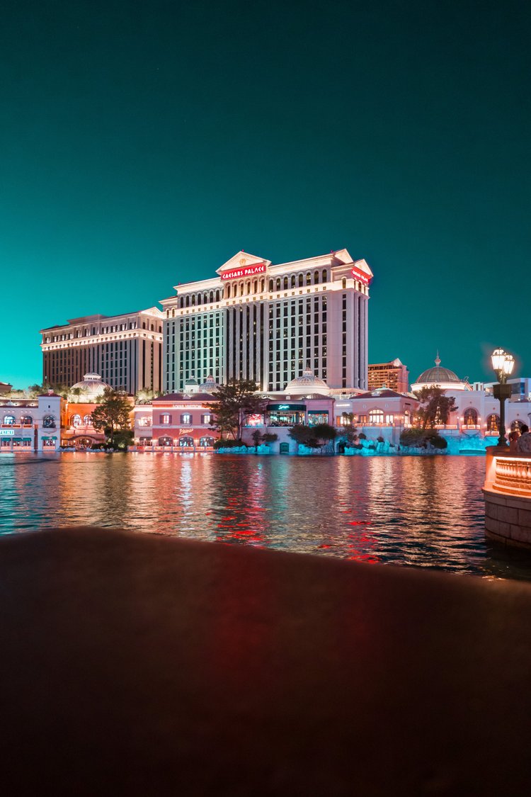 Hotel and casino reflected in water at night