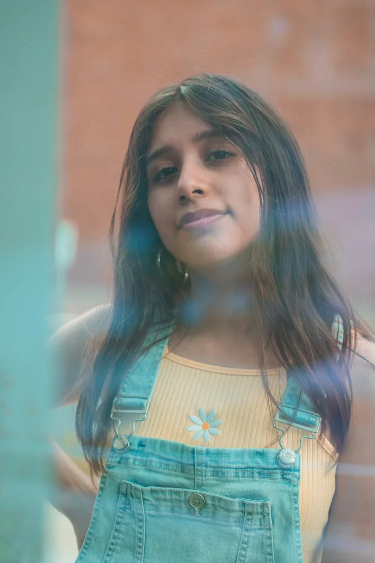 Young woman in denim overalls