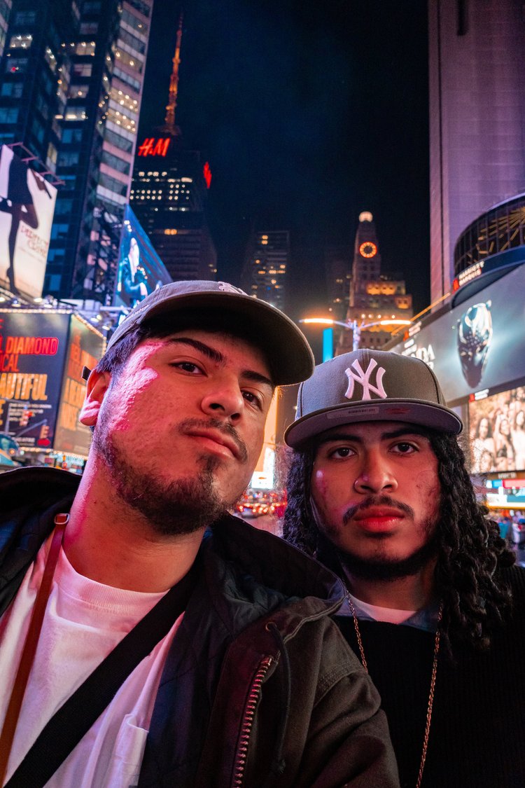 Two men taking a selfie in Times Square