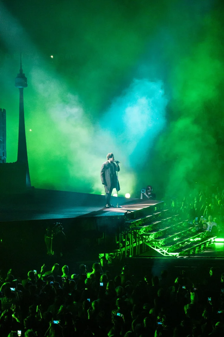 Performer in fog and green lights