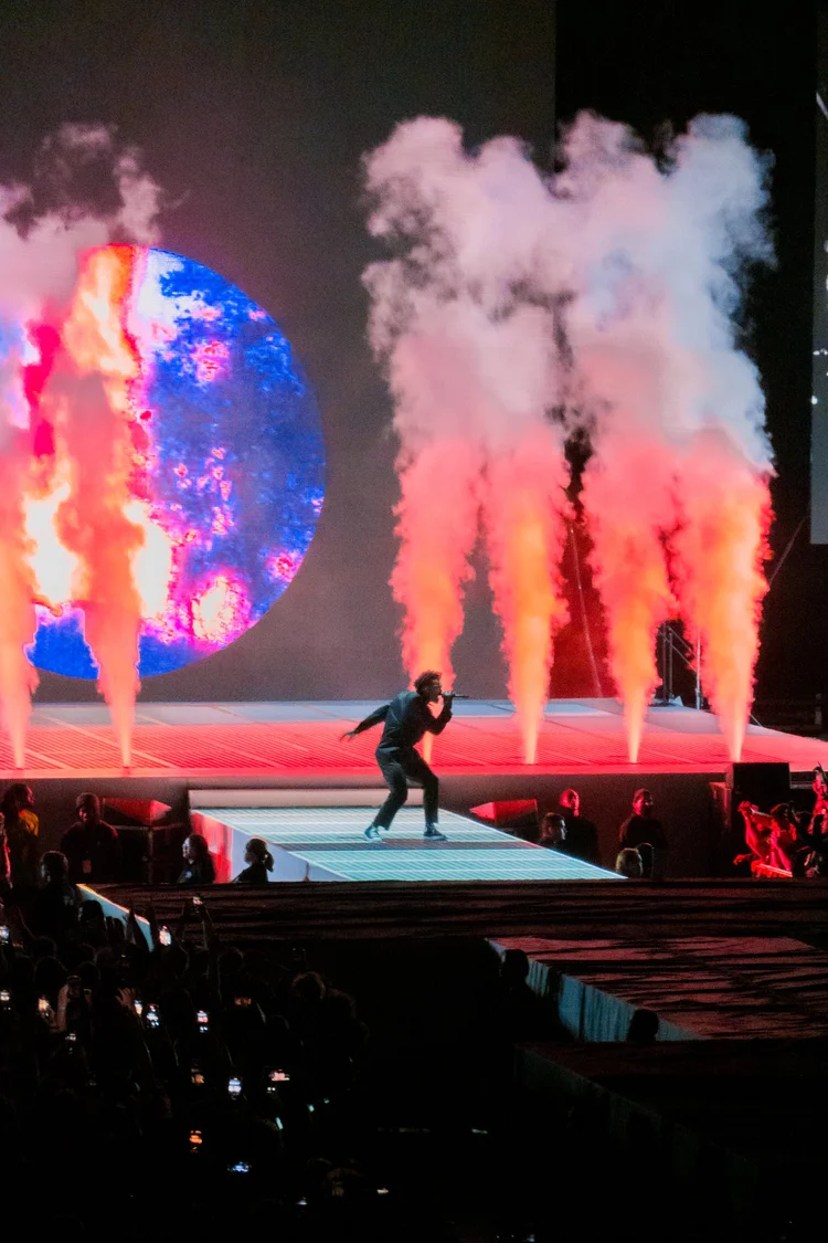 Performer with a planet on the screen