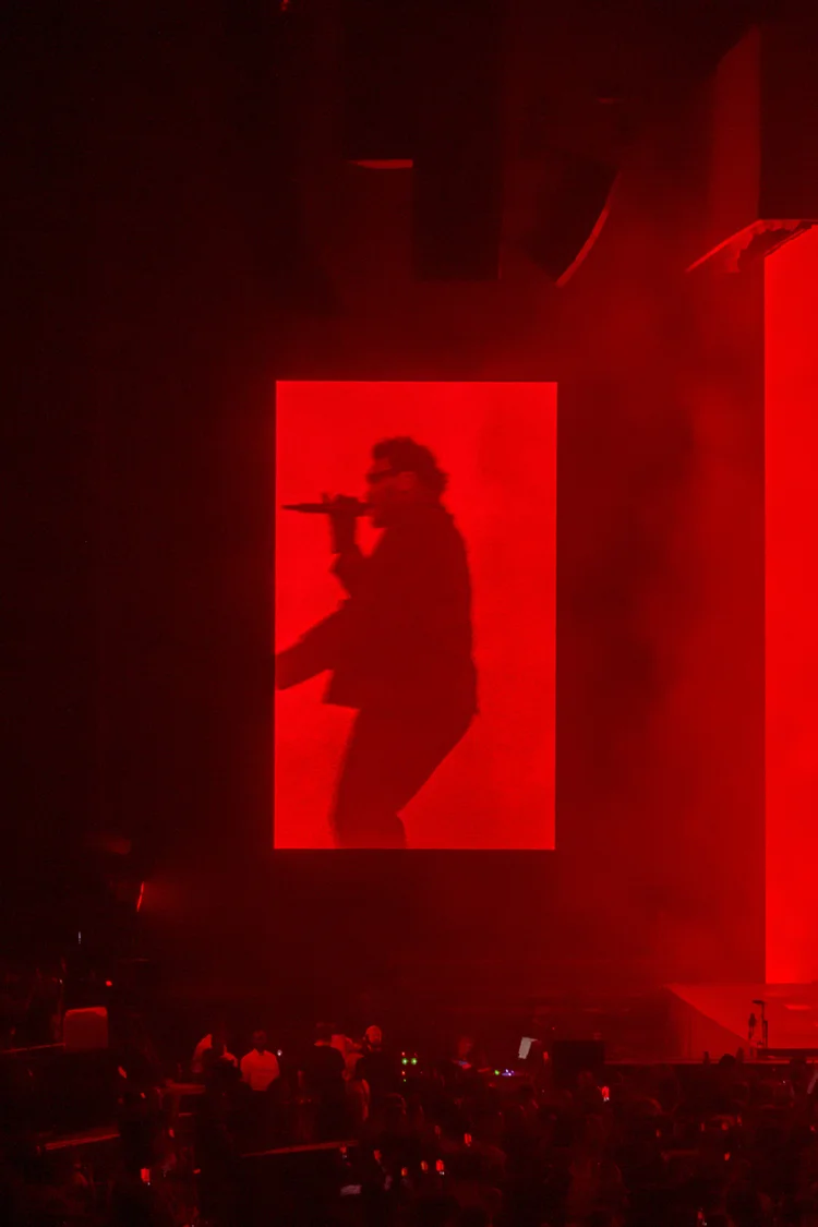 Red silhouette of a singer on a screen