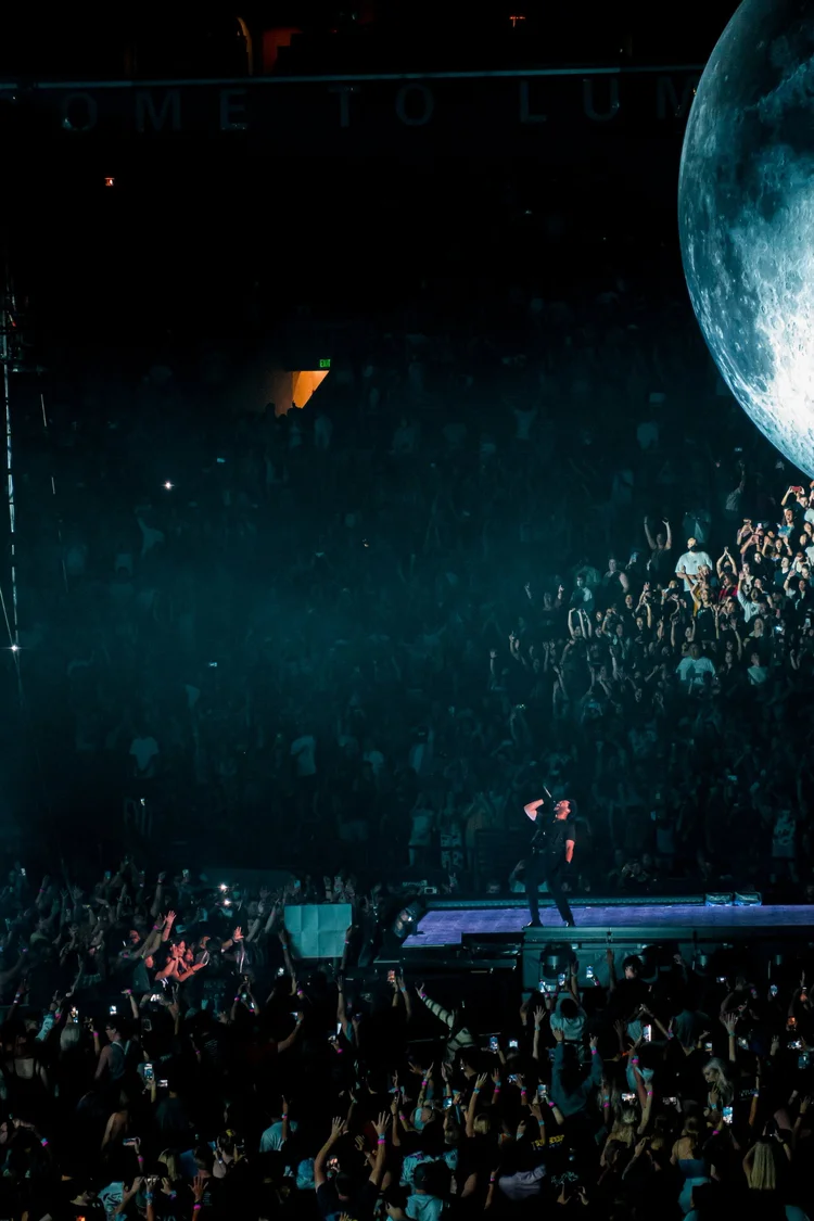 Performer with an illuminated moon prop