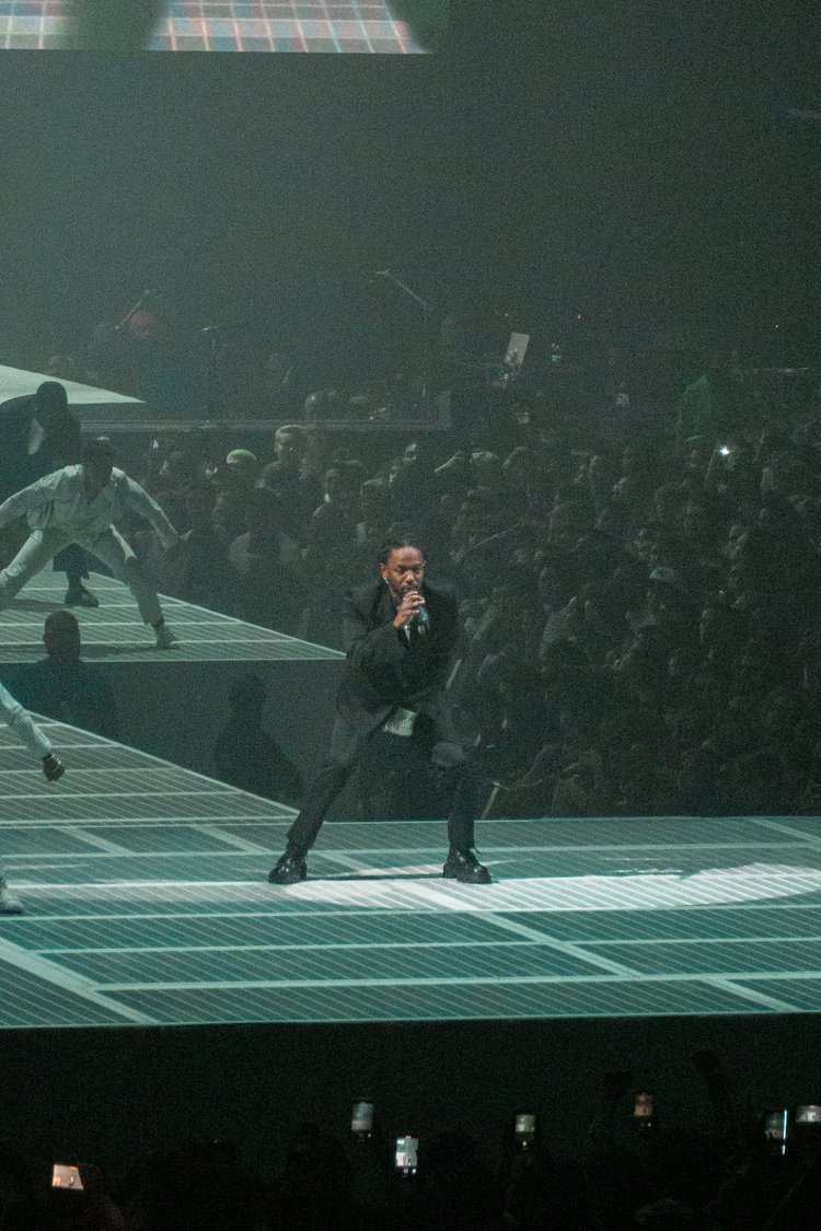 Performer singing with dancers