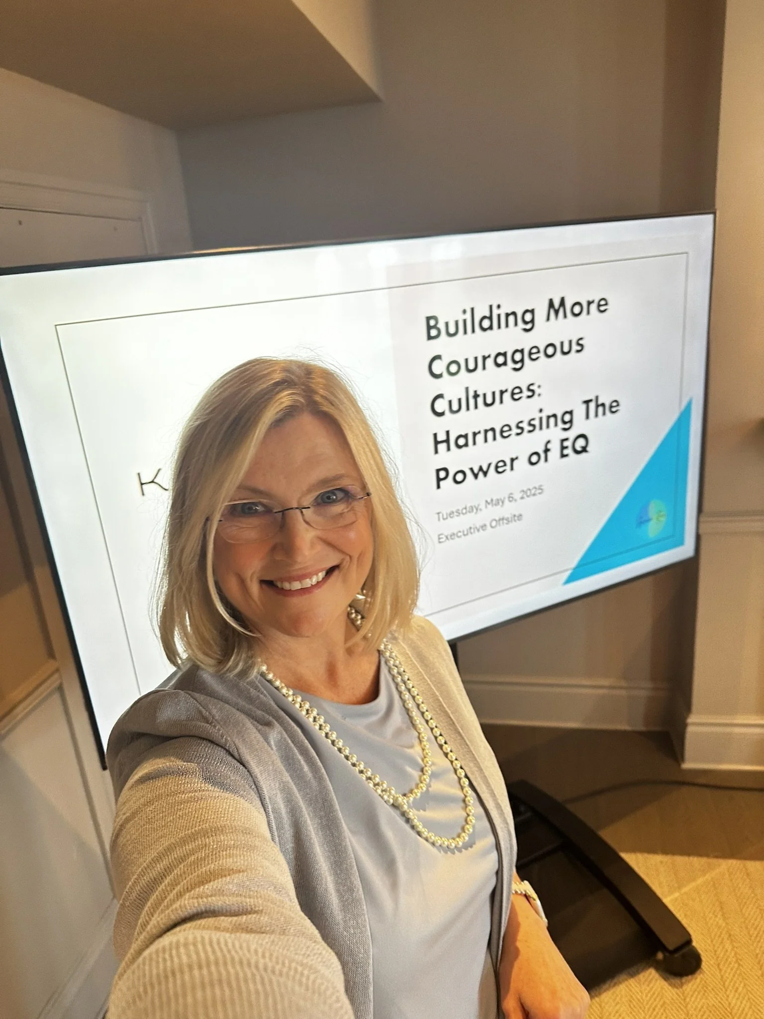 Arianne in front of a screen of slides for an emotional intelligence workshop