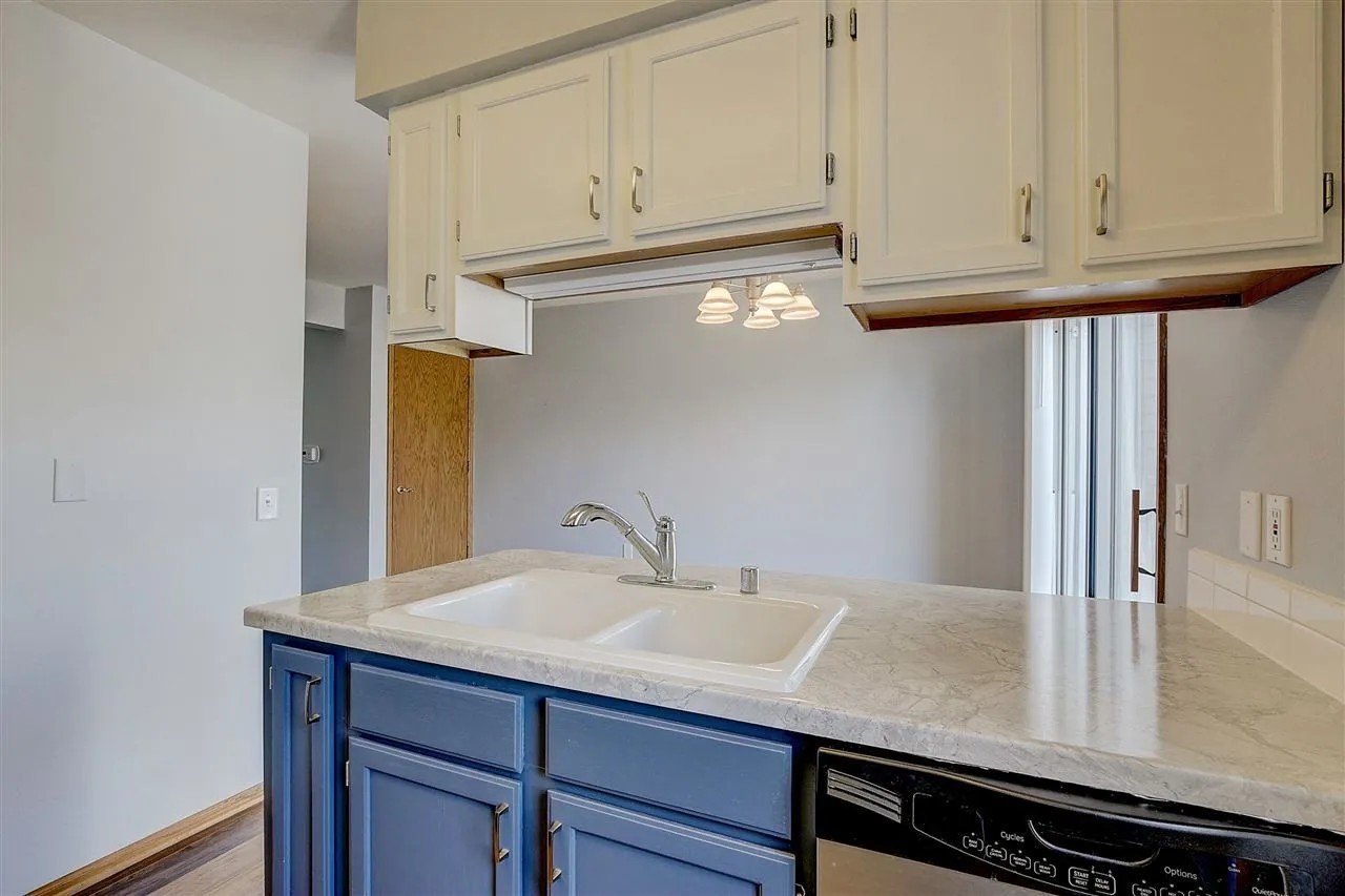 After: Refinished cabinets, countertop leveling, tile backsplash, shiplap finish on peninsula, new flooring_ Townhouse Kitchen