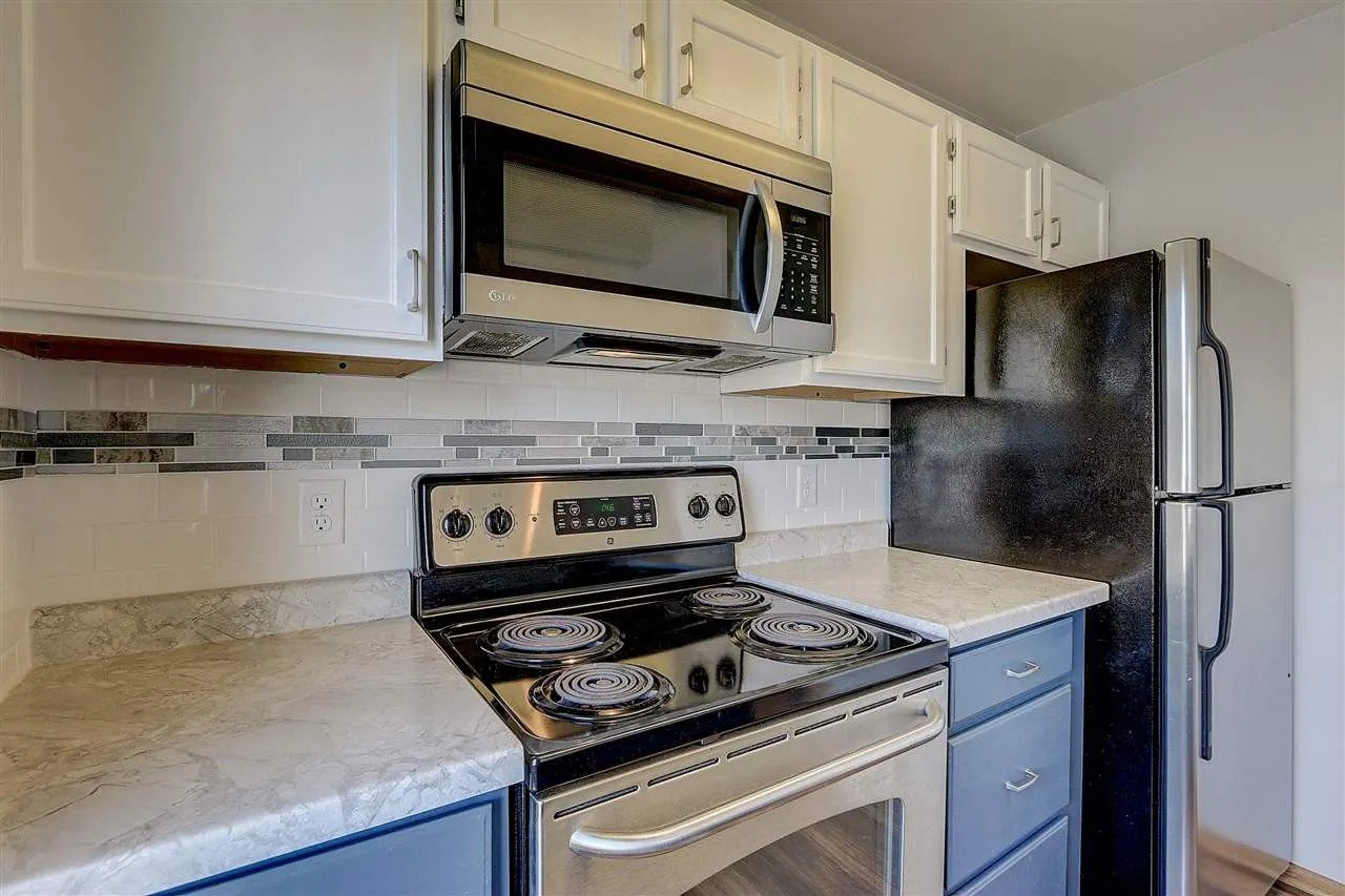 After: Refinished cabinets, countertop leveling, tile backsplash, shiplap finish on peninsula, new flooring_ Townhouse Kitchen