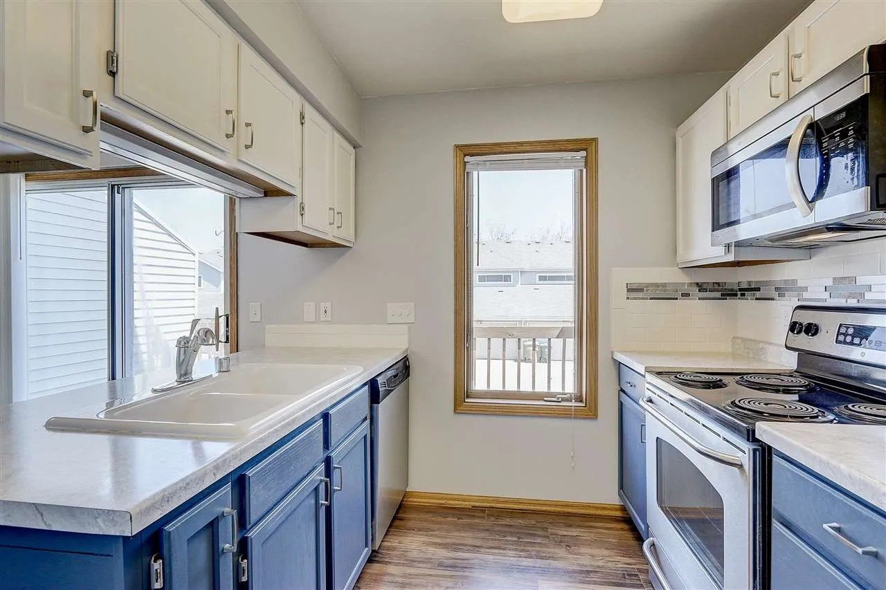 After: Refinished cabinets, countertop leveling, tile backsplash, shiplap finish on peninsula, new flooring_ Townhouse Kitchen