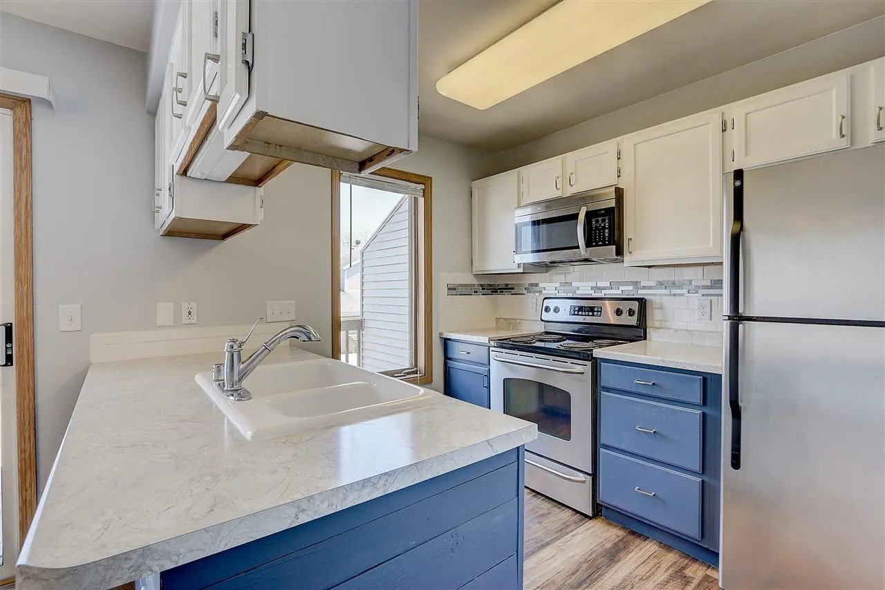 After: Refinished cabinets, countertop leveling, tile backsplash, shiplap finish on peninsula, new flooring_ Townhouse Kitchen