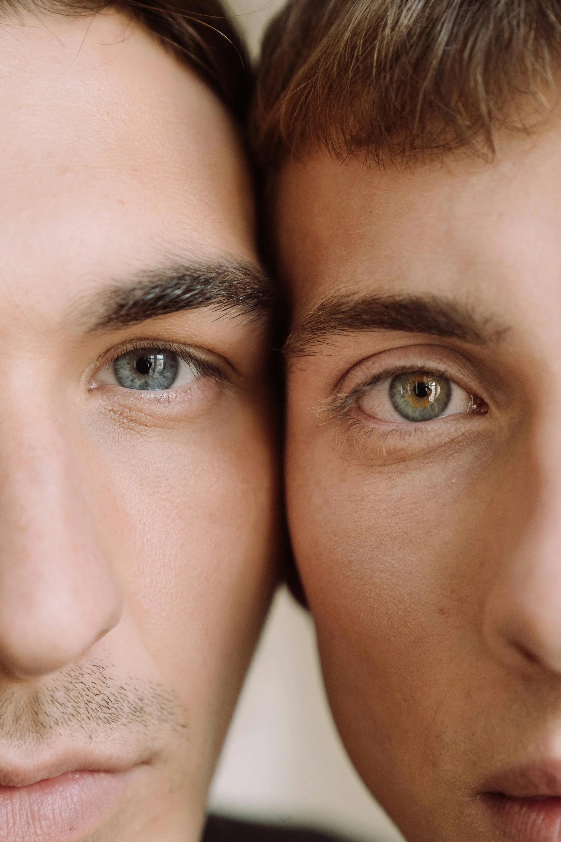 Close-up of two men's faces, showcasing eyes and eyebrows.