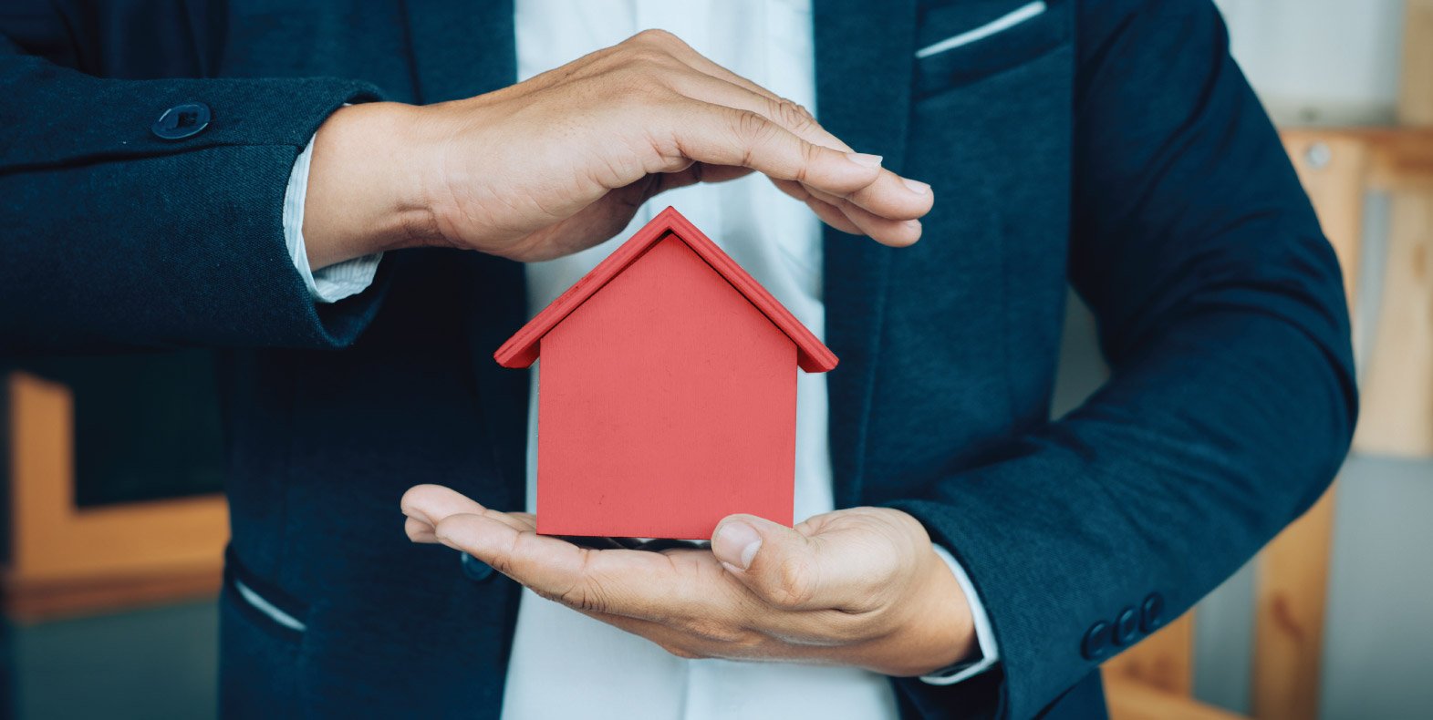 business-man-hand-hold-house-model-saving-small-house-1.jpg