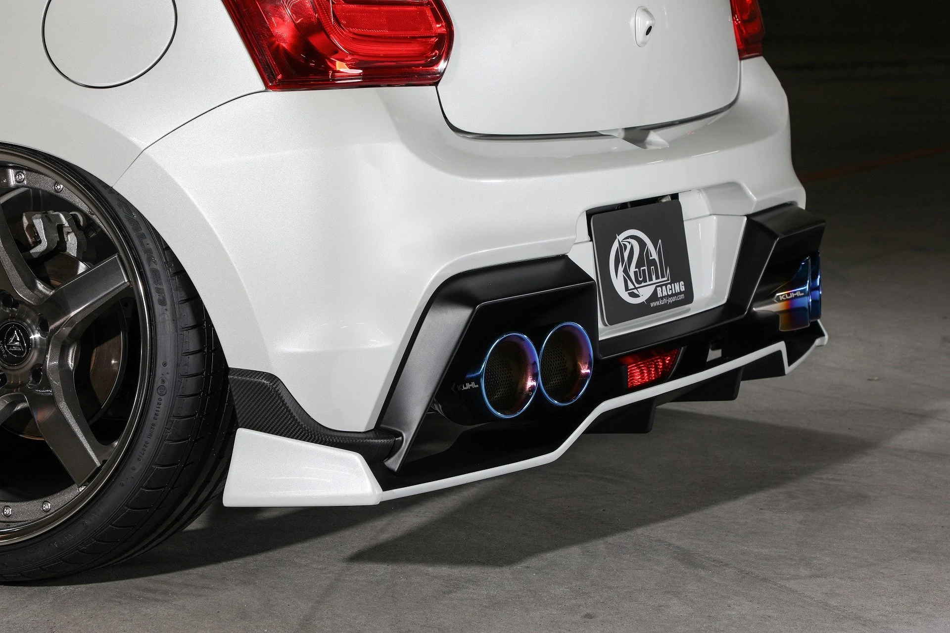 KUHL 33R-SS rear diffuser and blue four-tip exhaust close-up on Suzuki Swift Sport ZC33S.