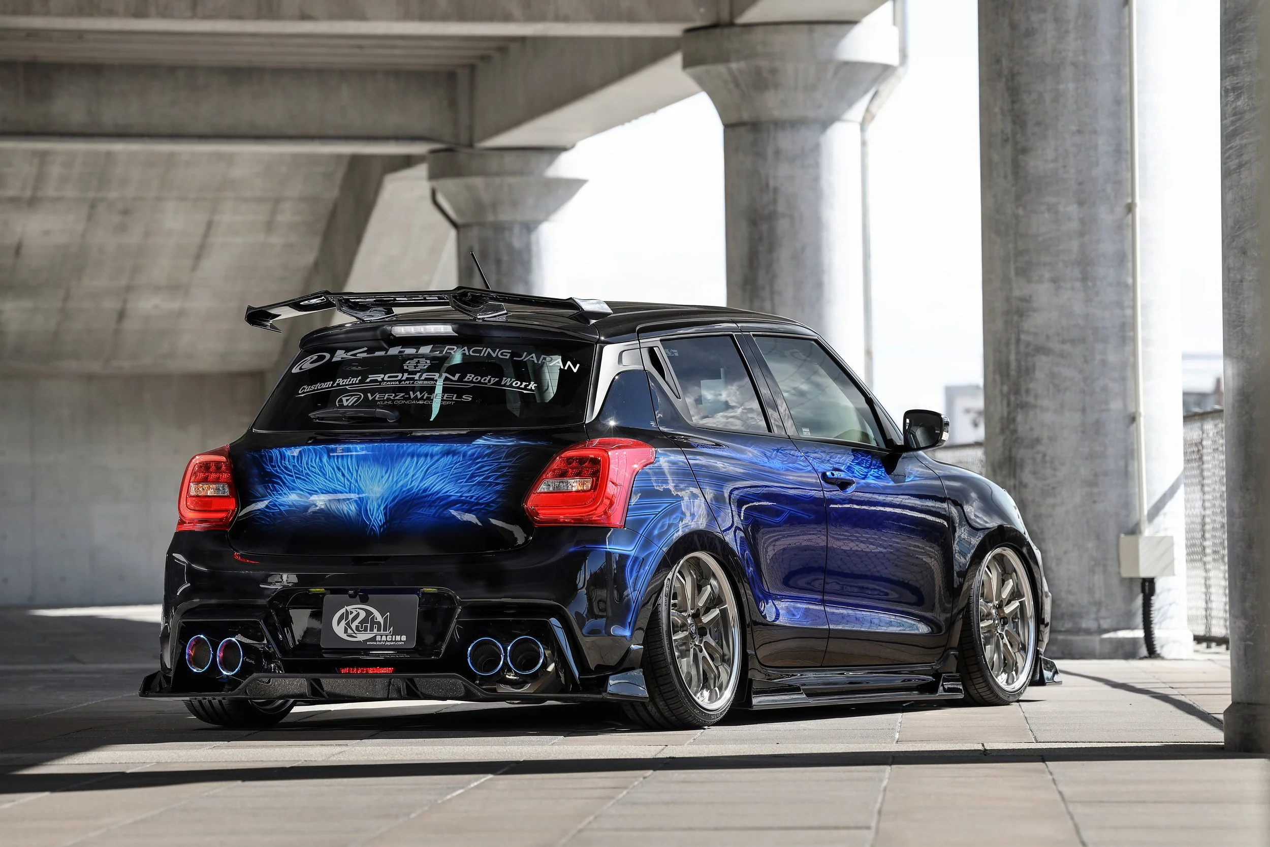 KUHL 33R-SS Suzuki Swift Sport ZC33S demo car, rear three-quarter view showing rear half spoiler, floating diffuser, four-tail exhaust and GT wing