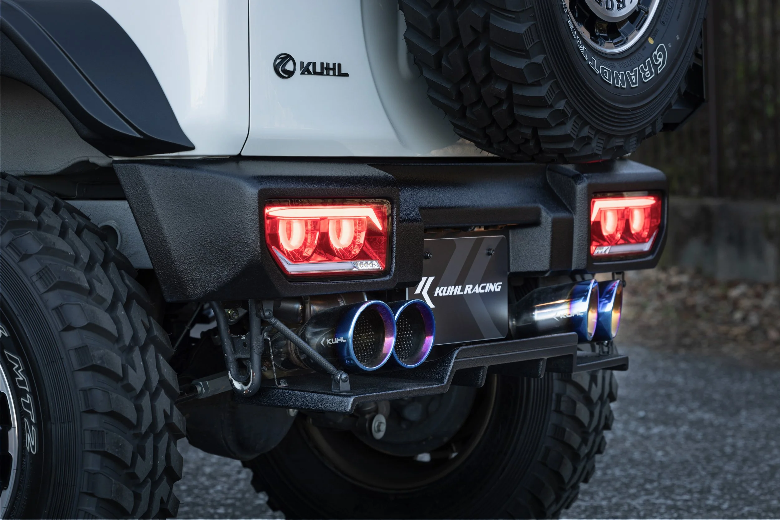 KUHL 74R-GT II rear bumper, Type 2 floating diffuser and heat-blue four-tail exhaust close-up