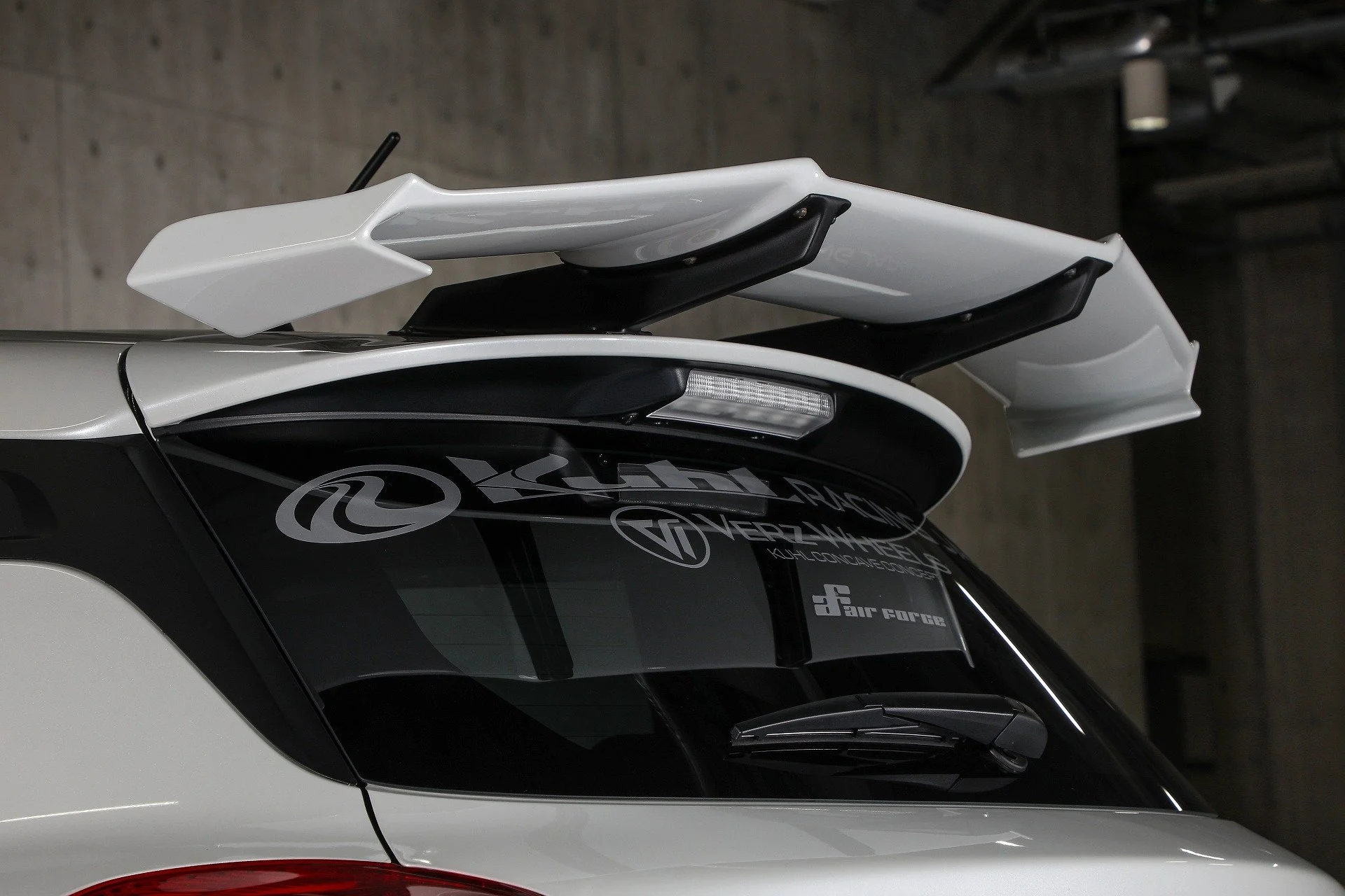 KUHL 33R-SS roof end GT wing and mounting supports close-up on Suzuki Swift Sport ZC33S.