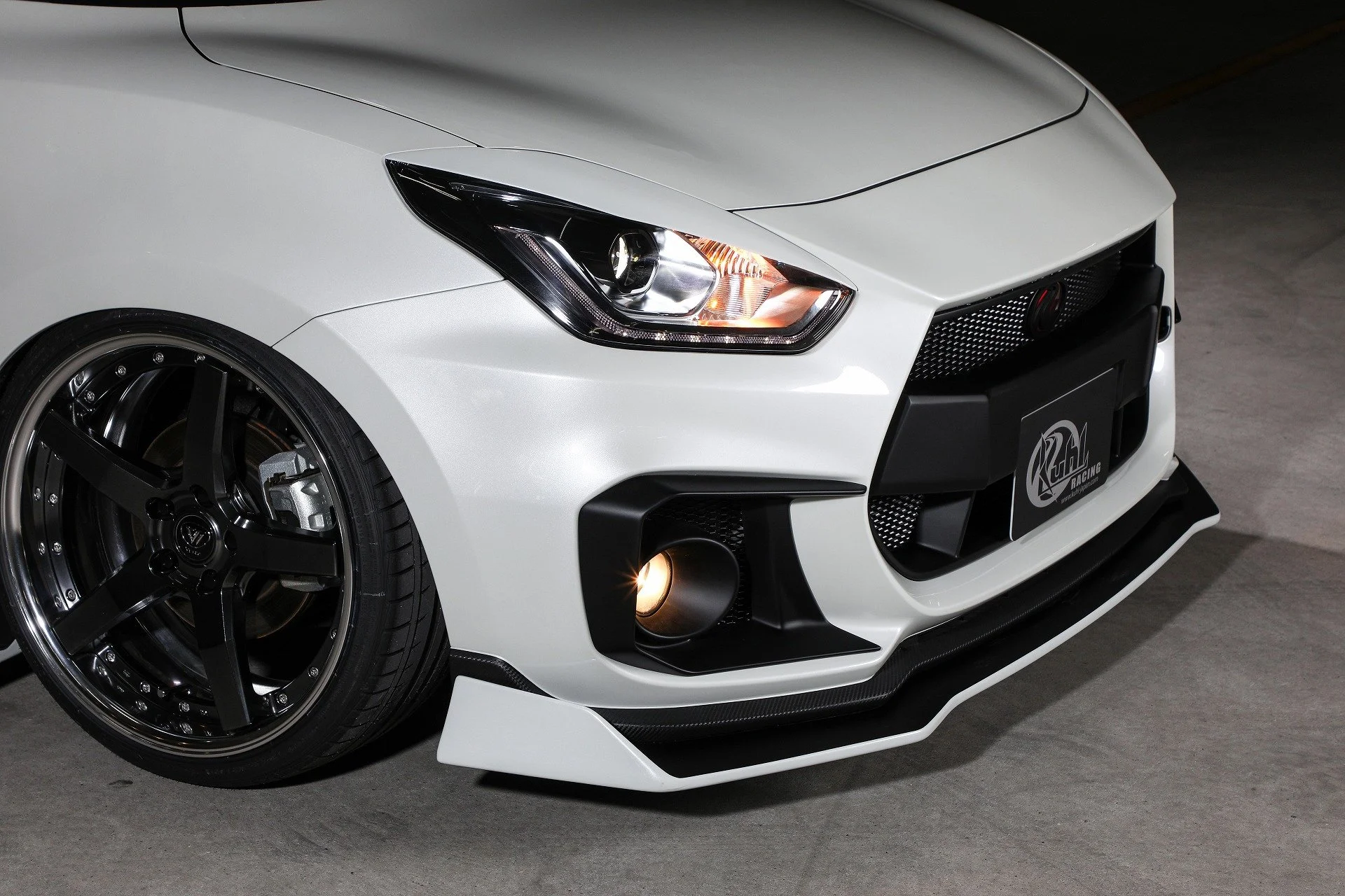 KUHL 33R-SS headlight eyelid, foglight cover and front diffuser detail on Suzuki Swift Sport ZC33S.