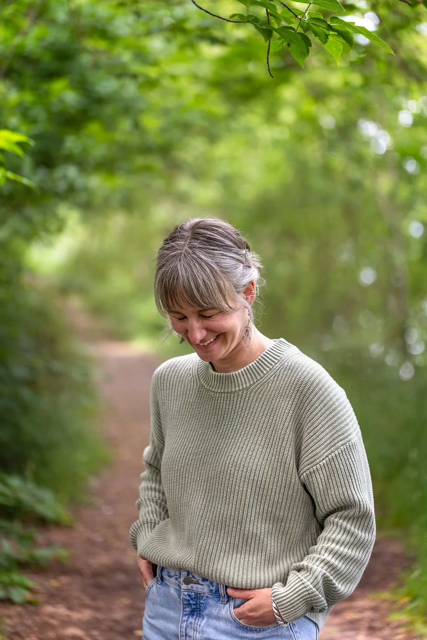 Jenny Fremlin walking along a peaceful forest trail in Salmon Arm, BC, reflecting the calm, grounded presence she brings to therapy.
