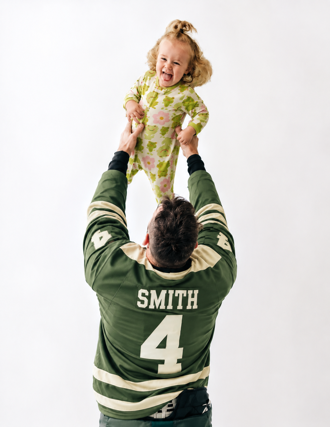 Arend Smith lifting his daughter Scarlett overhead as they share a joyful moment together, reflecting the importance of family, connection, and relationships in his life