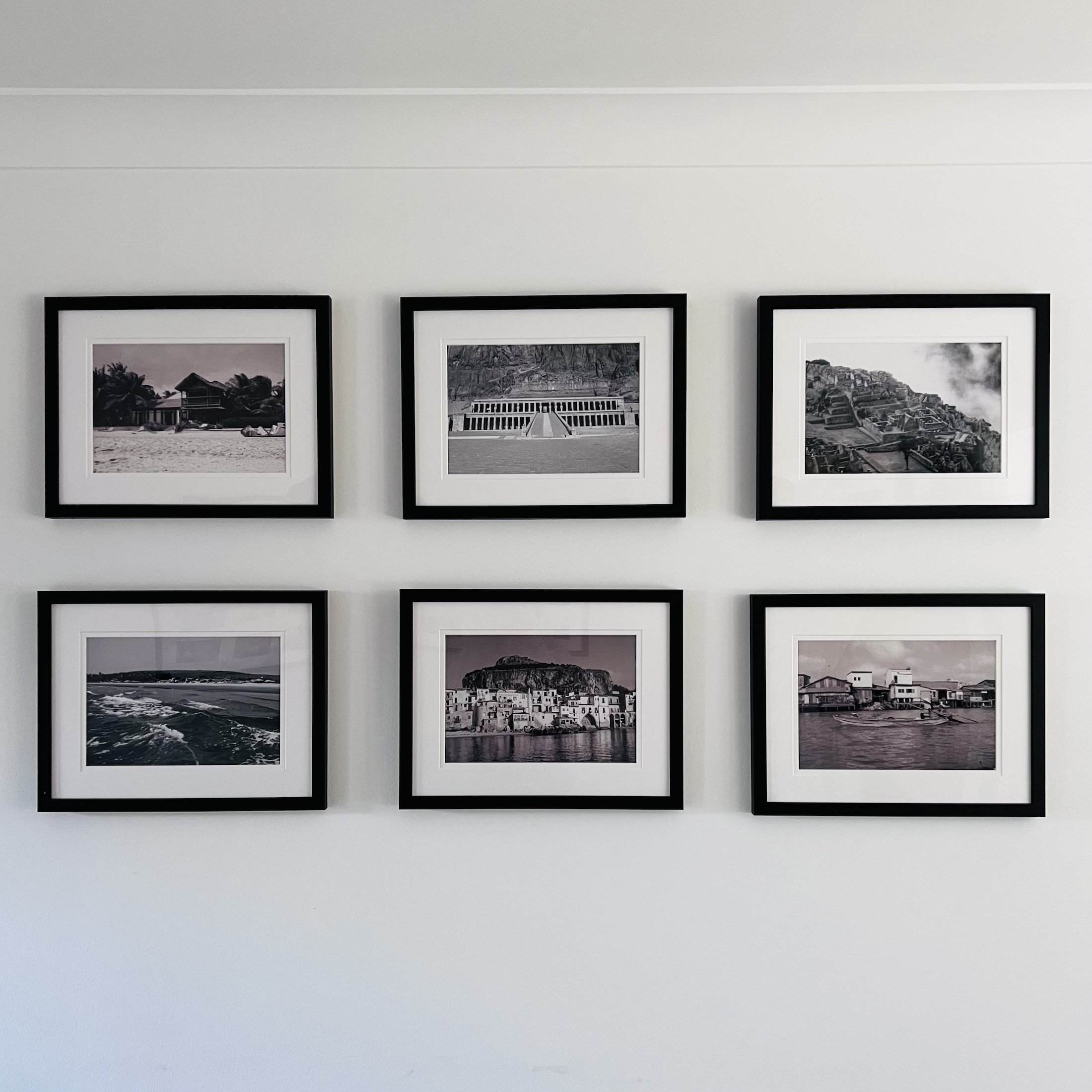 A gallery wall of six black and white photographs