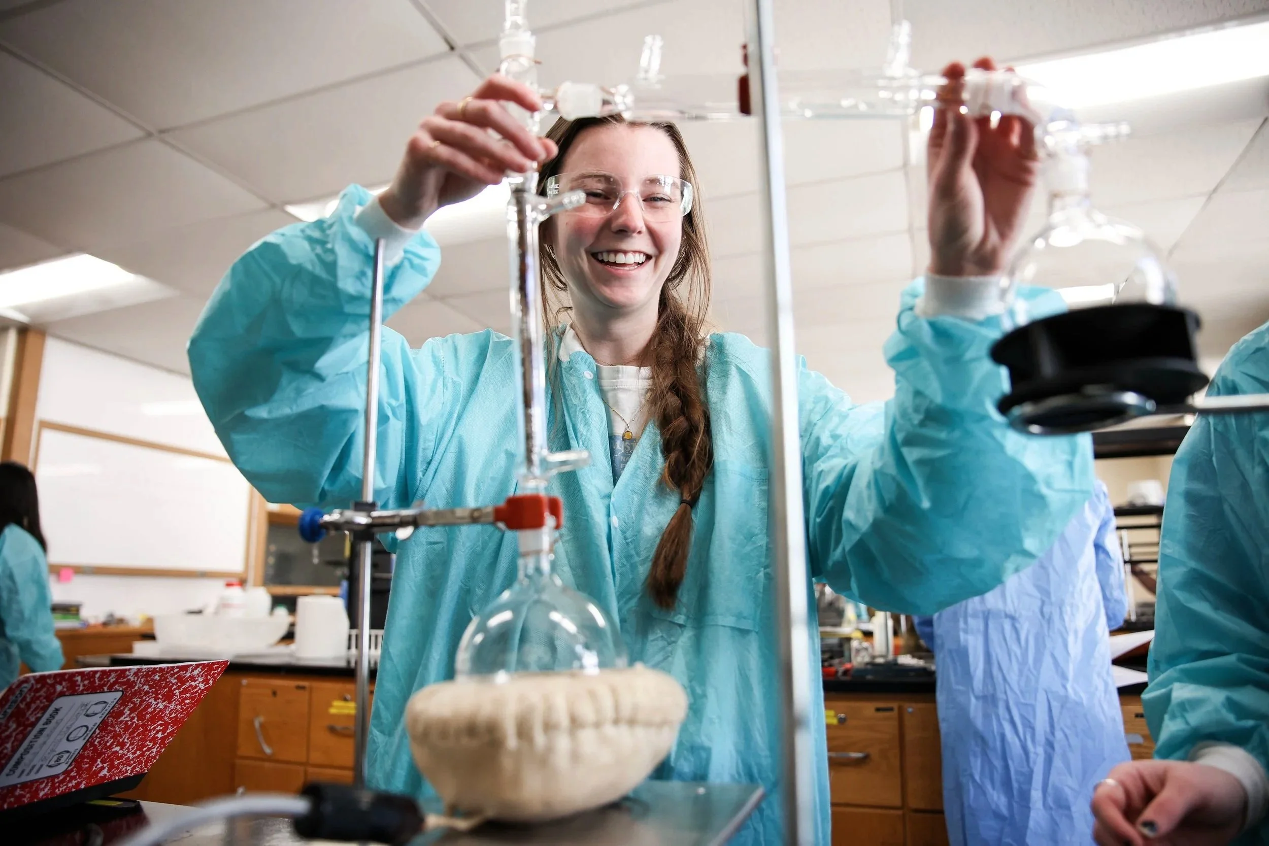 A student adjusts equipment and prepares
for the next step of an experiment during a
chemistry class in the Bowman Building.