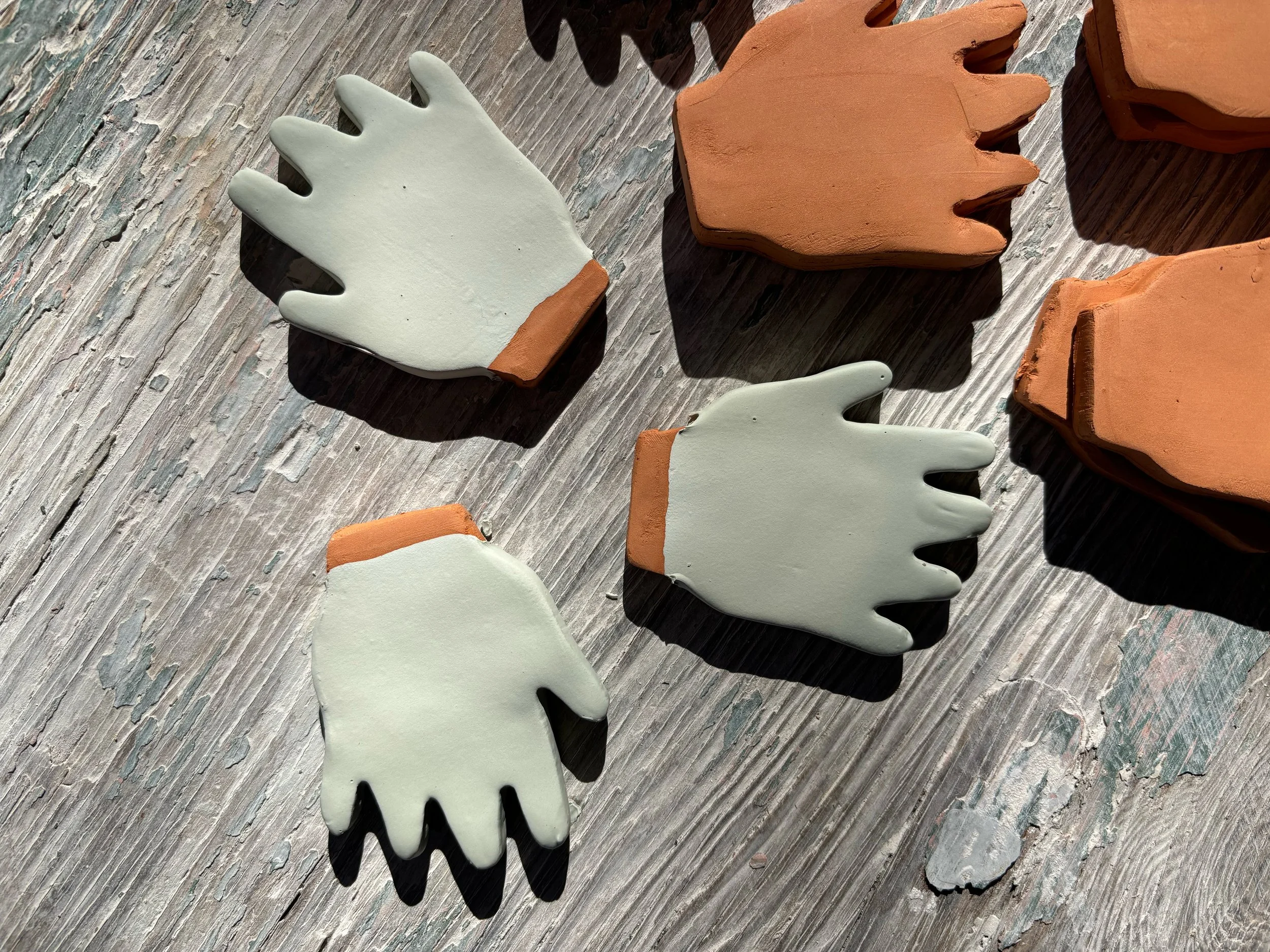 Clay alphabet letters shaped like G, O, A, T, and X on a weathered wooden surface