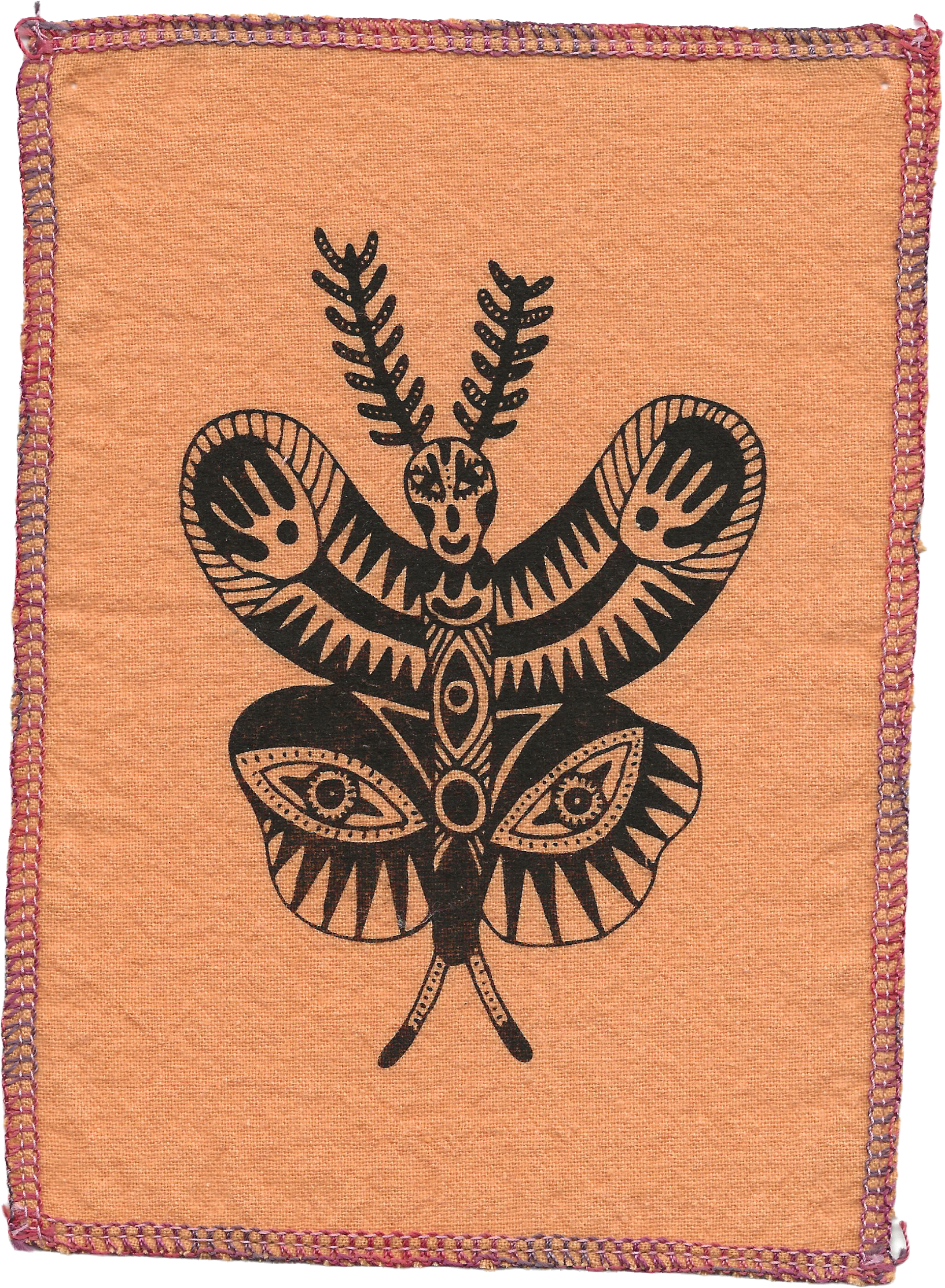 Orange fabric with a black totem-style butterfly design in the center, surrounded by pink and purple embroidered border.