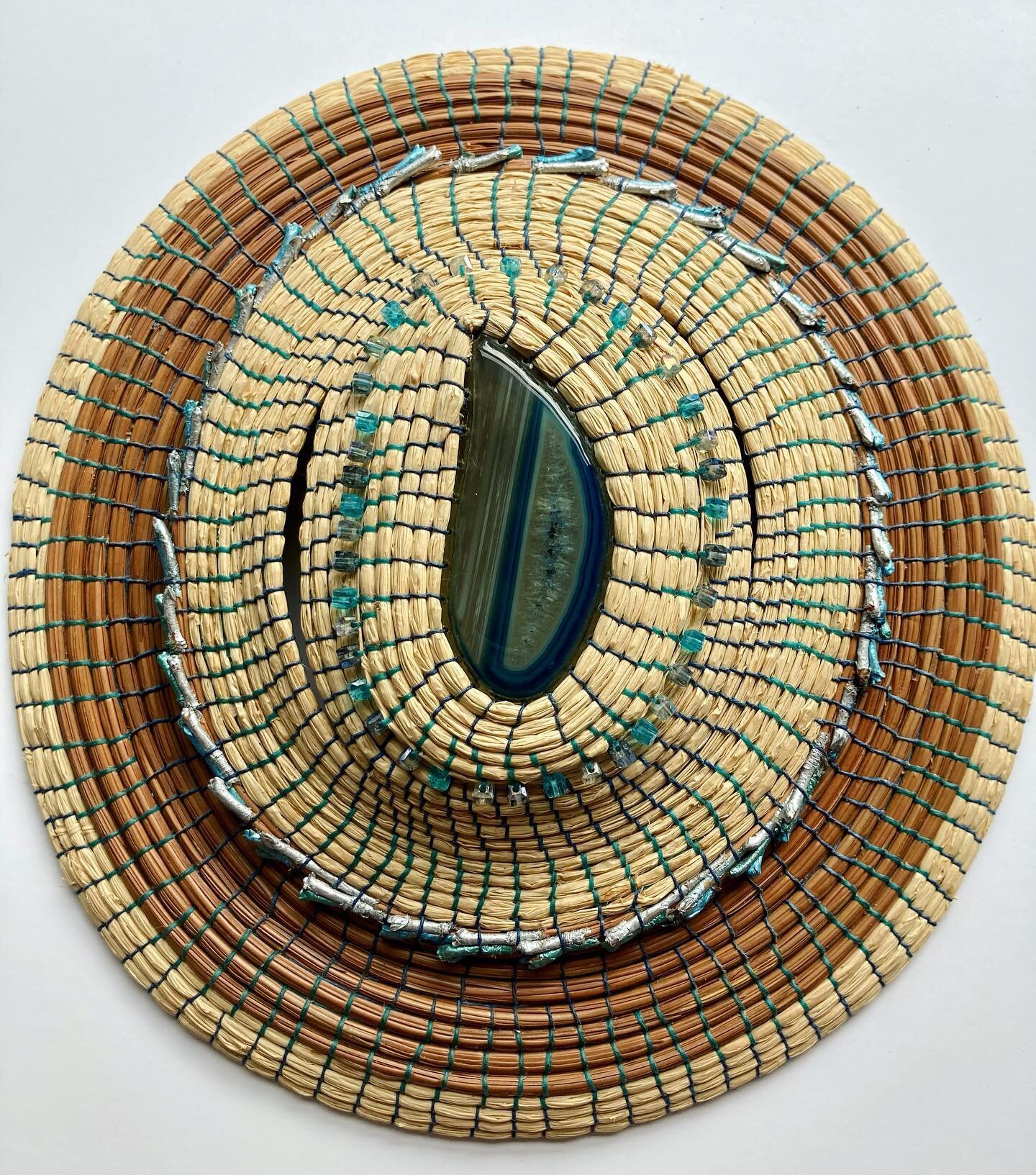 Finished!! I&rsquo;m loving the contrasting color of the pine needles and raffia in the piece. 

Blue agate stone center, raffia, pine needles, painted pine needle caps and glass beads

#baskets #basketry #basketryartist #basketryart #naturalbasketry