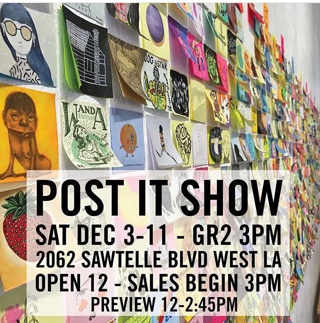 Wall decorated with colorful, framed art pieces and posters advertising a post art show event with details including date, time, location, and sales preview.