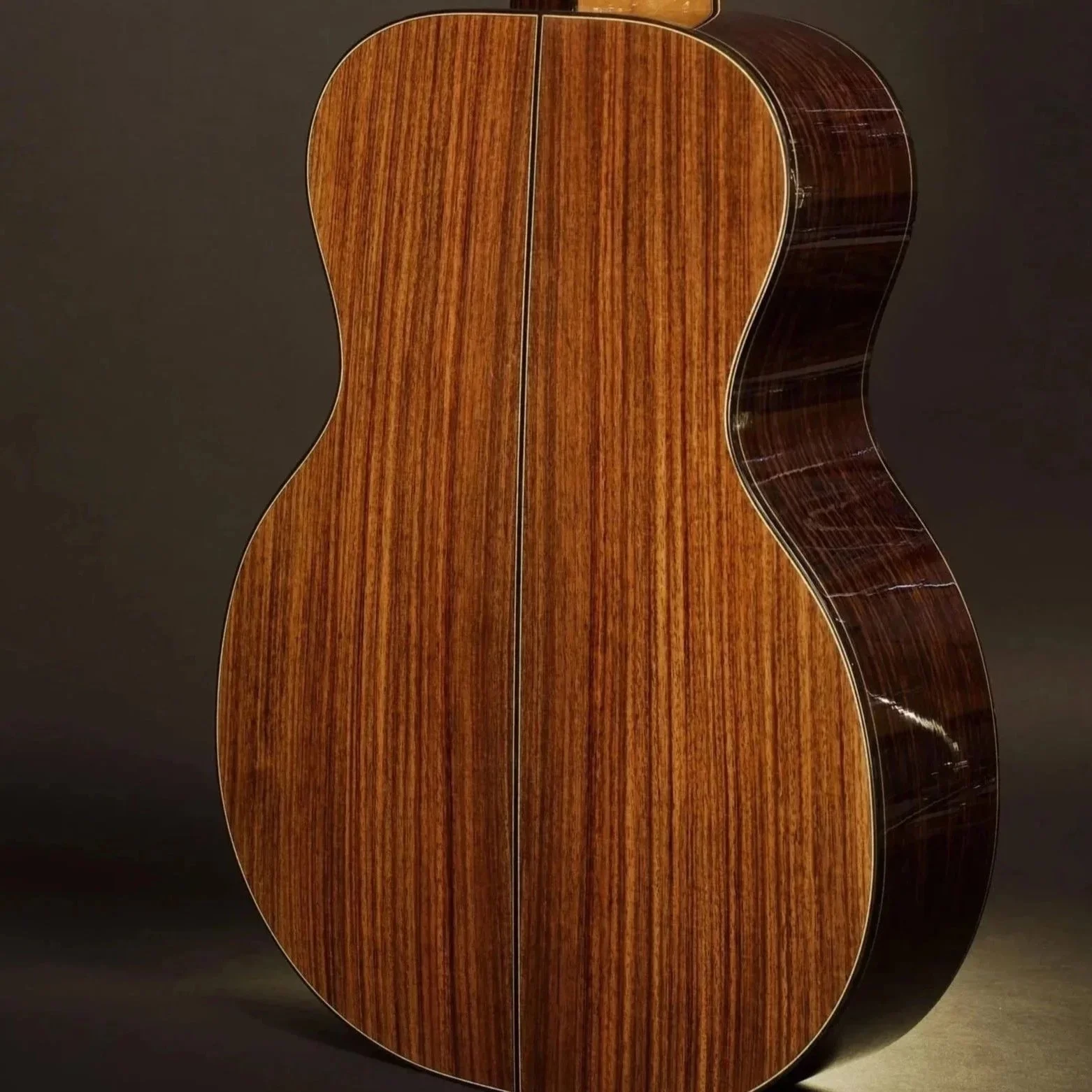 Dark red, black, grey and purple traditional back and sides acoustic guitar tonewood
