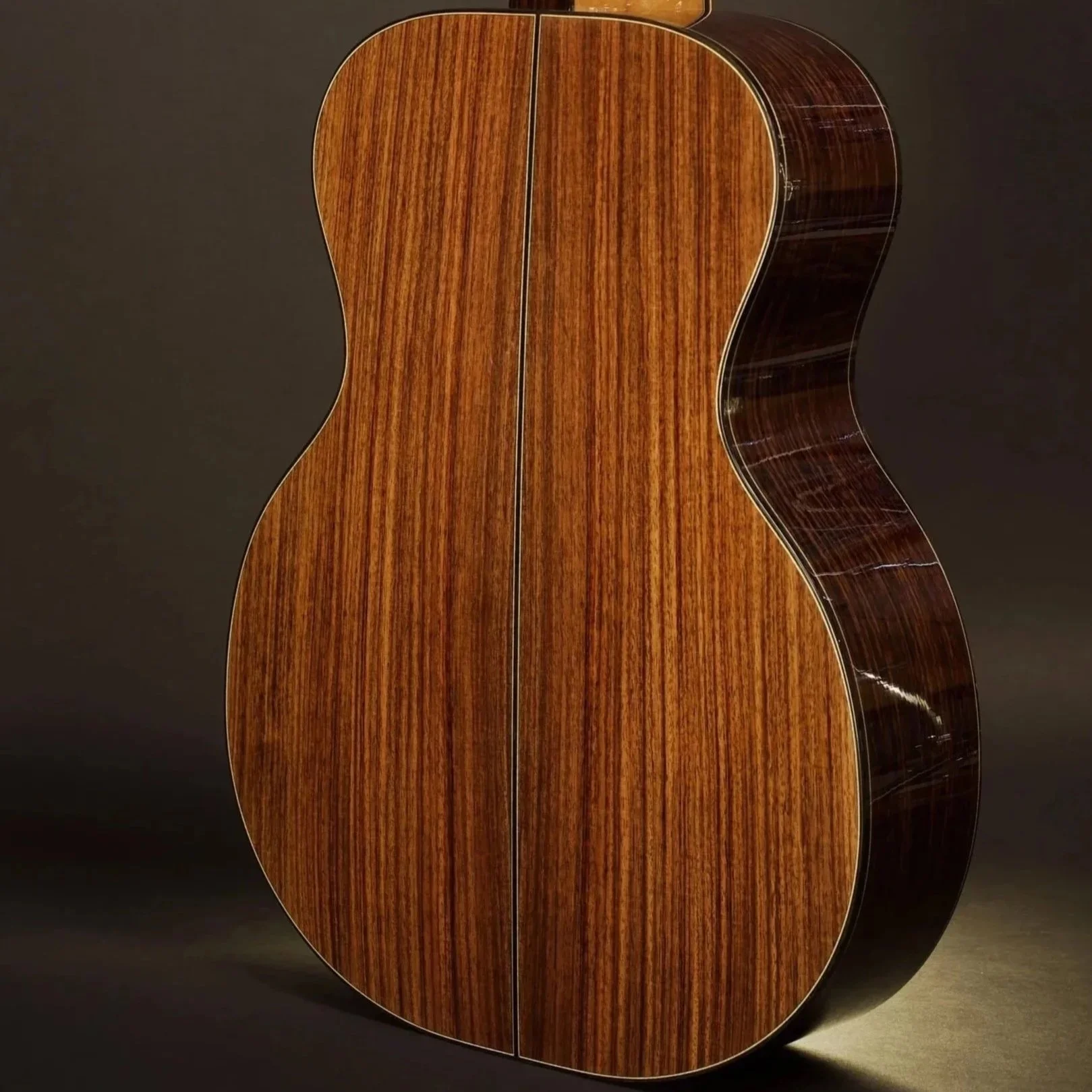 Dark red, black, grey and purple traditional back and sides acoustic guitar tonewood